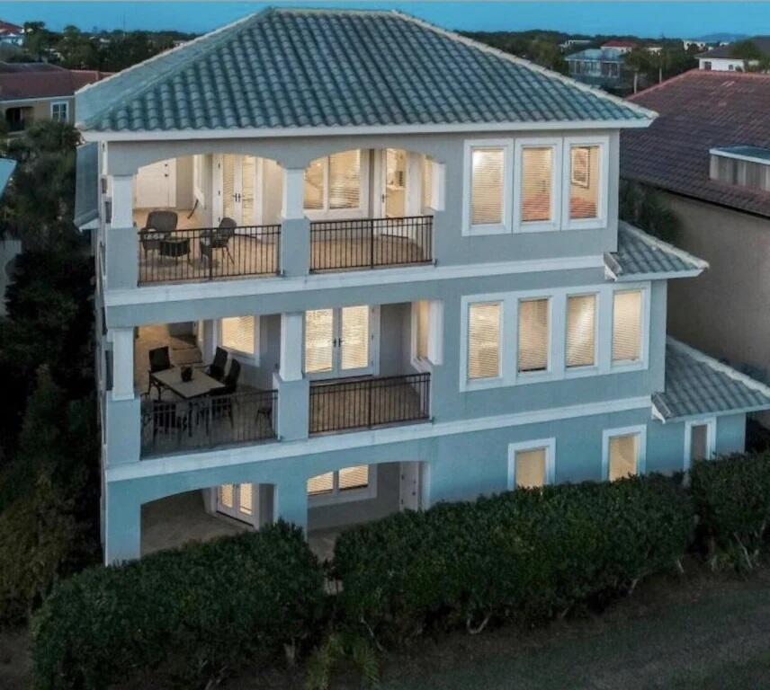 Exceptional opportunity abounds with this gorgeous 4,339 sqft, 5 bedroom rental machine ideally located on Scenic Highway 98 within the prestigious gated community of Destiny East. Expertly positioned, this outstanding property takes full advantage of gorgeous gulf view corridors and close proximity to the lakefront community pool & beach access. This rental magnet scales three stories in height and conveys fully furnished with recent updates including all new interior paint & professional decor as well as fresh landscaping. Notable features include a private elevator, spacious open floor plan, two car garage with a third golf cart parking stall, chef's kitchen complete with stainless steel appliances, granite countertops and custom cabinetry. Oversized wrap around balconies characterize