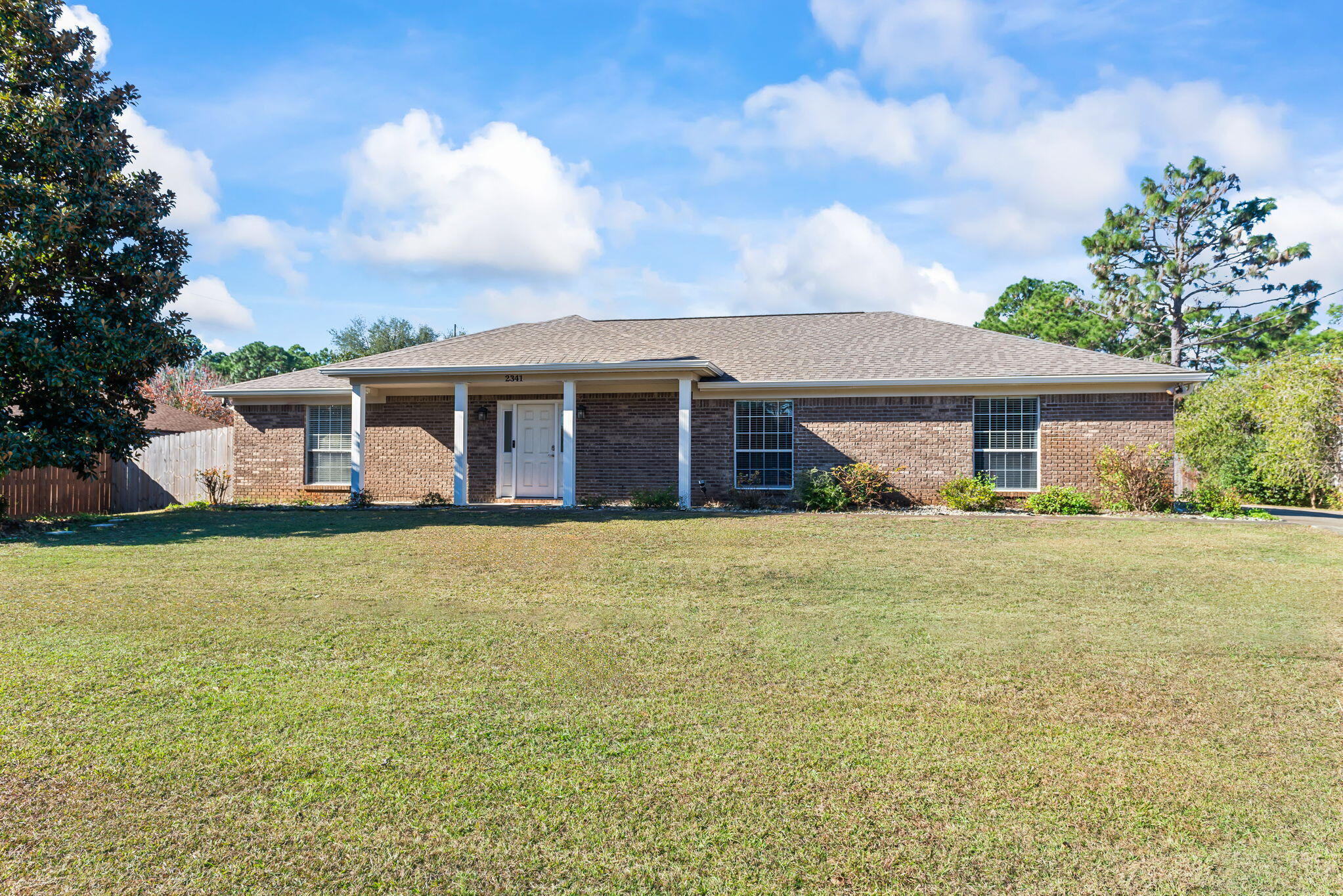 UNBELIEVABLE 2.25% VA ASSUMABLE MORTGAGE! Within minutes to NAVARRE BEACH and the Shops of Navarre including NEW RESTAURANTS AND STORES. Easy commute to Hurlburt Field or Pensacola. NO HOA! All brick, 4-bedroom, split floor plan home on an OVERSIZED HALF-ACRE lot - plenty of ROOM TO PARK your BOAT, RV AND create the backyard of your dreams! The GARAGE IS HUGE - park 2 cars and have room for extra storage on either side. Recent improvements also include a PAVER PATIO and PERGOLA! Inside, the living room is large enough to fit all of your furniture and it also includes a GAS FIREPLACE! The master suite has a WALK-IN SHOWER, separate GARDEN TUB, DOUBLE vanity and TWO WALK-IN CLOSETS. The remaining three bedrooms are all good sized and privately located on the opposite side of the home.