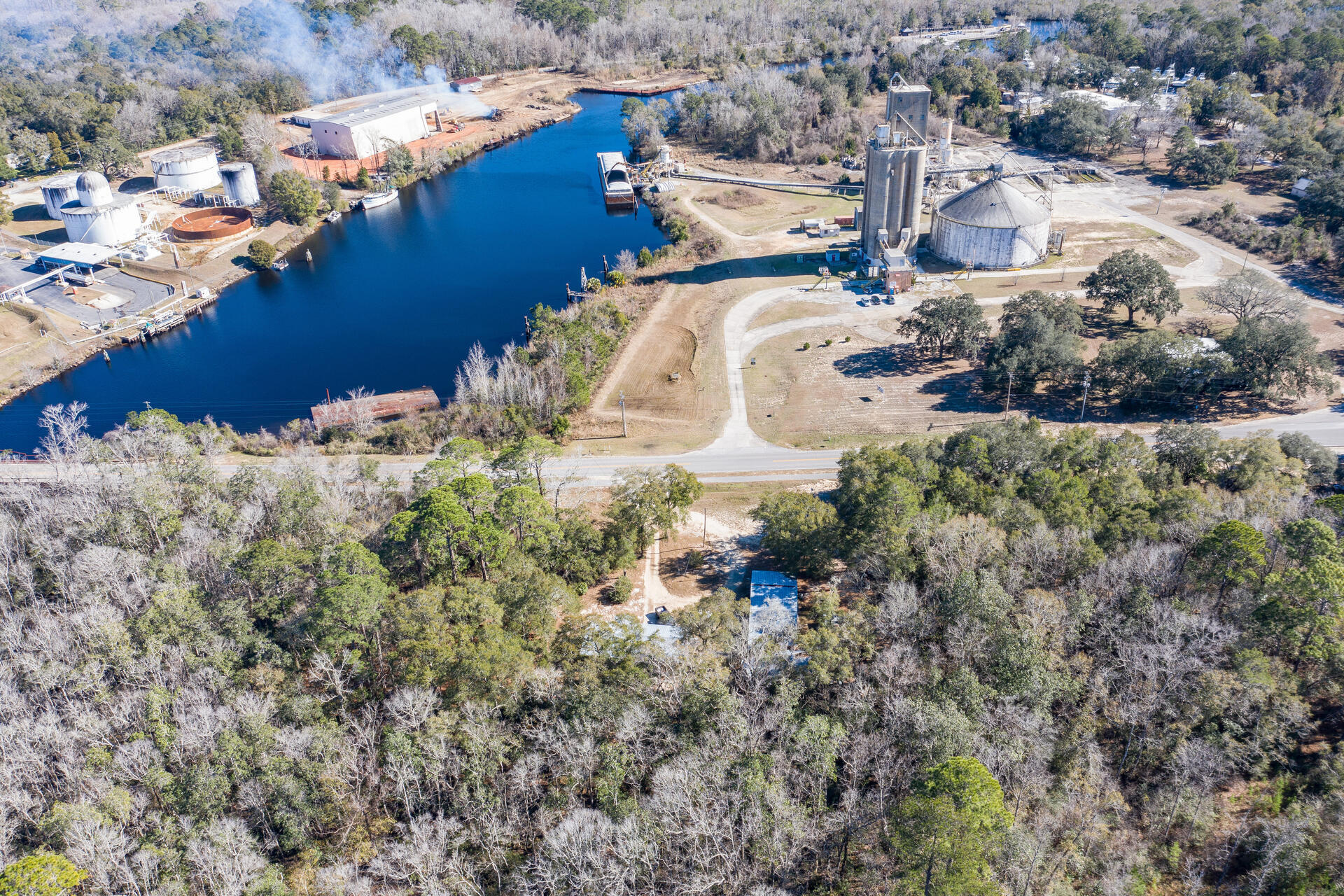 POSSIBILITIES are endless in downtown FREEPORT! This 1.28 acre tract has two existing homes with pole barns sold AS IS and is set in downtown Freeport in a location that can bring opportunity for the owner to build new or redevelop into a list of possibilities including bait/tackle/ice store or restaurant to support new marina across from the property. Or three townhomes.....This tract has 335 feet of Bay Loop frontage. Imagine fisherman and boaters getting bait, tackle, ice and sandwiches before they go out for the day! The views of the bayou are fantastic to watch the waterway and boat traffic. It is one of a kind!
