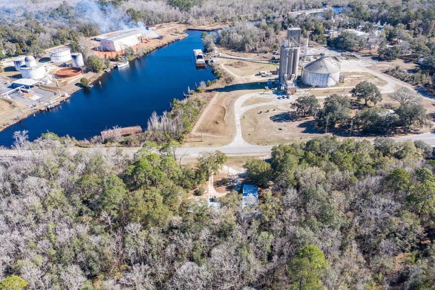 POSSIBILITIES are endless in downtown FREEPORT! This 1.28 acre tract has two existing homes with pole barns sold AS IS  and is set in downtown Freeport in a location that can bring opportunity for the owner to build new or redevelop into a list of possibilities including bait/tackle/ice store or restaurant to support new marina across from the property. Or three townhomes.....This tract has 335 feet of Bay Loop frontage. Imagine fisherman and boaters getting bait, tackle, ice and sandwiches before they go out for the day! The views of the bayou are fantastic to watch the waterway and boat traffic. It is one of a kind!