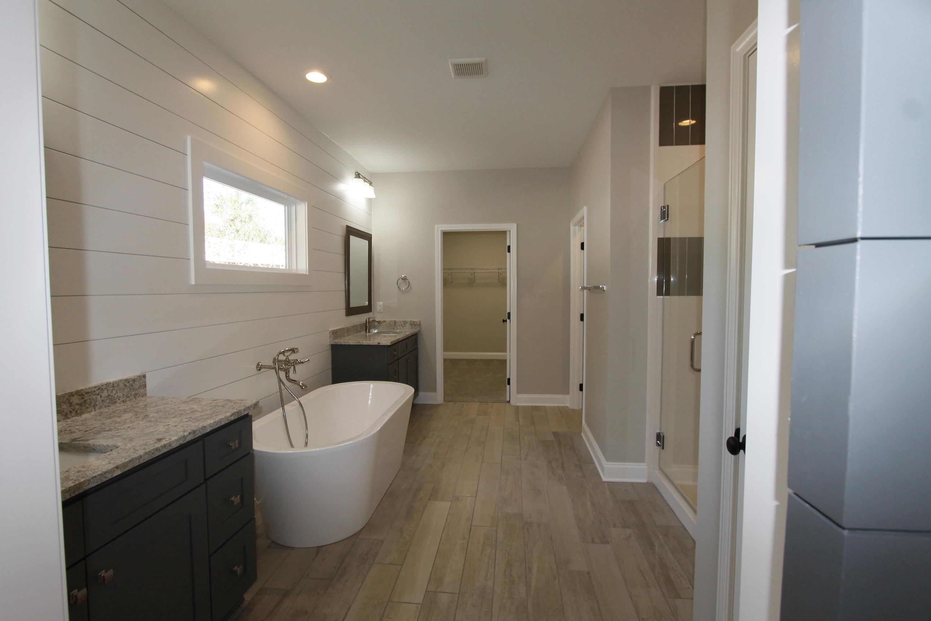 Awesome new plan! Golf cart friendly neighborhood, super close to shopping, downtown restaurants and 10 minutes from Destin. This 4/3 custom brick home has super curb appeal and is being constructed on a large lot with beautiful mature trees. There are 10 Ft. Ceilings w/ impressive crown molding, has plank tile flooring throughout the main living and wet areas, and 5 1/4'' baseboard throughout. At the right of the living room is the gourmet kitchen which boasts Espresso colored cabinetry, granite countertops, a counter level breakfast bar and stainless appliances (including an oversized commercial grade frig./freezer and beverage cooler). All cabinetry features soft close glides and hinges. A walk-in pantry is located at the rear of the kitchen. Bedrooms 1 and 2, and bath 1, are located at the far left of the home. Bedroom 3 and bath 2 are located at the left of the kitchen. The master suite is located at the right rear of the home, is very roomy, has a large walk - in closet, a custom tiled walk - in shower with glass enclosure, a classic stand alone bathtub, a double vanity and a linen closet. Master bath has an awesome barn door entry. The laundry room is conveniently located at the right of the homes entrance from the garage, and has a barn door. There is also a "mud area" at the left entrance of the grage for storing shoes, etc, as well as a large coat closet. The yard is beautifully landscaped, has a privacy fence, and comes complete w/ a sprinkler system, well, pump and timer. Insurance will be very reasonable, as home is built to today's code. Plan and survey are attached.