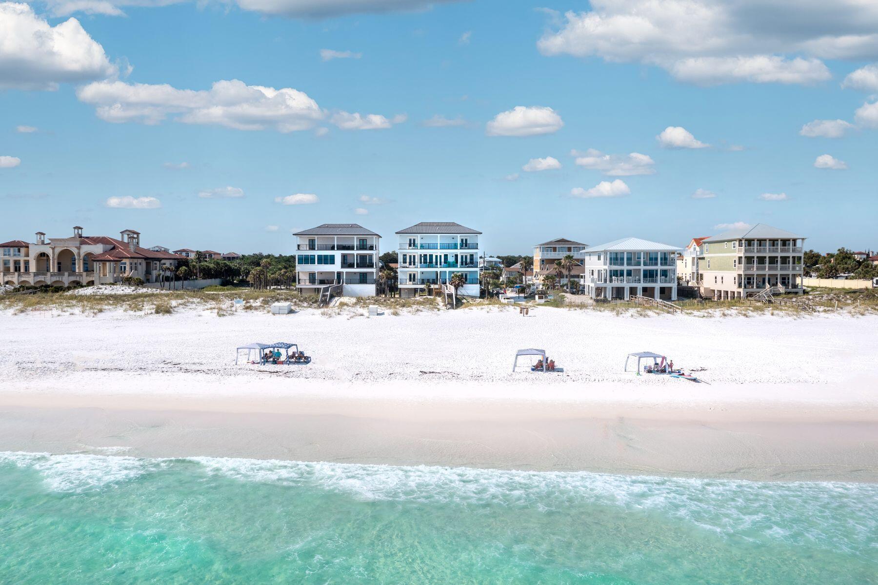 Prominently seated atop the sugar white sand dunes of Miramar Beach, this artistically constructed Gulf front masterpiece awaits. Perfect for those longing for a highly amenitized second home or portfolio property, this beach retreat is perfect for large groups, family reunions or beach weddings. Outfitted in luxurious finishes such as Quartz countertops and designer tile throughout, the perfect elevated touches assist in elevating the experiences by all who spend time within this expansive property's walls. Designed to capture the breathtaking sights of the Gulf of Mexico only footsteps away, five of the property's eight bedrooms offer direct Gulf views, sure to charm guests and owners alike. An uncrowded beach will ensure you get front row access to the sparking emerald waters of the