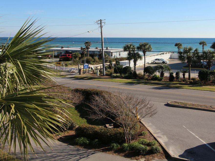 $24,000 to $28,000 RENTAL PROJECTION FOR 2020! BEACH GETAWAY! Your own piece of paradise & it's directly across from the beach & a public beach access! Nice gulf view from large wrap around balcony & the living room. Cute one bedroom beachy condo with bunks. The kitchen is white  light & bright! There is plenty of room for dining with a bar-height table & four chairs plus a breakfast bar with stylish bar stools. Floors are wood-look throughout except in bath. A stackable washer & dryer is an added convenience. Grand Caribbean East is a great complex in the heart of Crystal Beach. It has a heated pool, grills, & picnic area. Enjoy a short walk to Camille's Restaurant & Sidewalk Cafe. Close to Destin Commons & many fun restaurants.