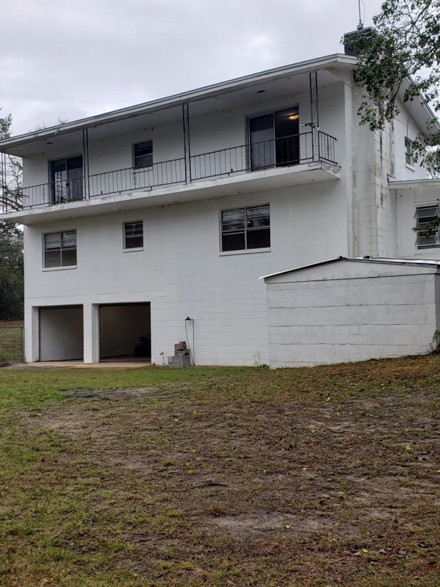 New Ac at Full price!   Lot of house for the money 2600 SF 4/2/2C Garage on Beautiful 13.4 acre parcel located on Boy Scout Road.  Property has an active Spring in back and interior has beautiful hardwood flooring. Must see this great opportunity before it's gone. Come and see what country living is like in Defuniak Springs. Located just outside of Town and just 30 minutes to the beautiful Emerald Coast Beaches. Home is dated and need of some TLC.