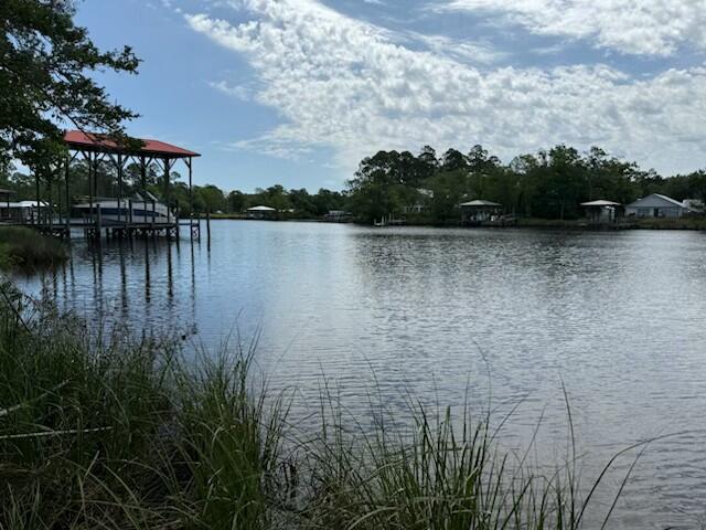 Water Lot Home with 80 ft of water frontage. Incredible opportunity to have New construction by Traton Homes. $25k towards dock, upgrades or closing costs when using a Traton Homes Preferred Lender. This highly desirable ranch plan home reflects one level living at its finest. The Largo home plan boasts 4 bedrooms and 3 full baths with a 3-car garage. The kitchen is bright and airy with quartz counter tops, cabinets to the ceiling, floating shelves, island and large walk-in pantry. Tile floors and tile surrounds to the ceiling in all bathrooms. Zero entry shower in Main Bathroom, $3,500 lighting fixture allowance, wood tongue and groove in foyer ceiling, Epoxy garage floor, Bahama gravel driveway. The large covered screened back porch will have incredible views of the water.