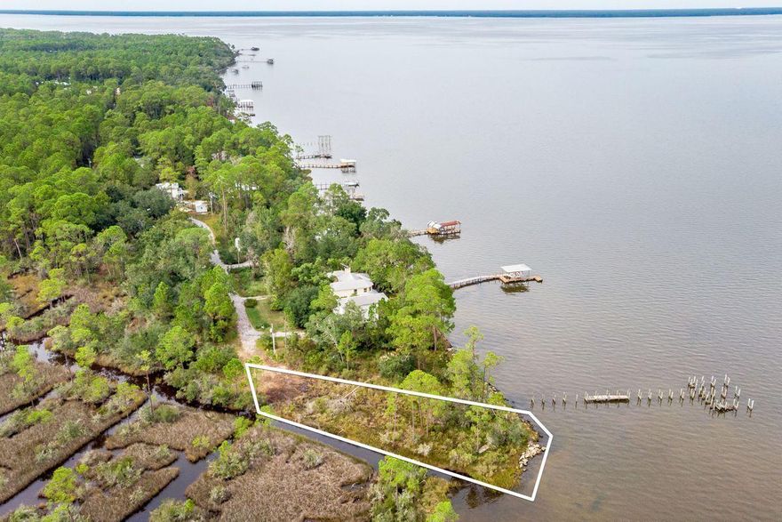This beautiful home site with sweeping water views more than 180 on the Choctawhatchee Bay is awaiting owners with a dream of living a waterfront lifestyle. Construction on navigable waterways is always scrutinized, and that step is already complete with ACOE approved building permit. Located at the end of a non-through street for quiet and privacy and within 5 miles to sandy beaches, restaurants, shopping, and entertainment. Fishing, boating, kayaking and watching the sun rise and set deliver home entertainment in a big way. Ask for the survey and site plan of this .47-acre slice of paradise. Nature abounds with indigenous vegetation, birds, dolphins and wildlife. Within your budget and your imagination lies the perfect new residence, or investment property for your new season of life