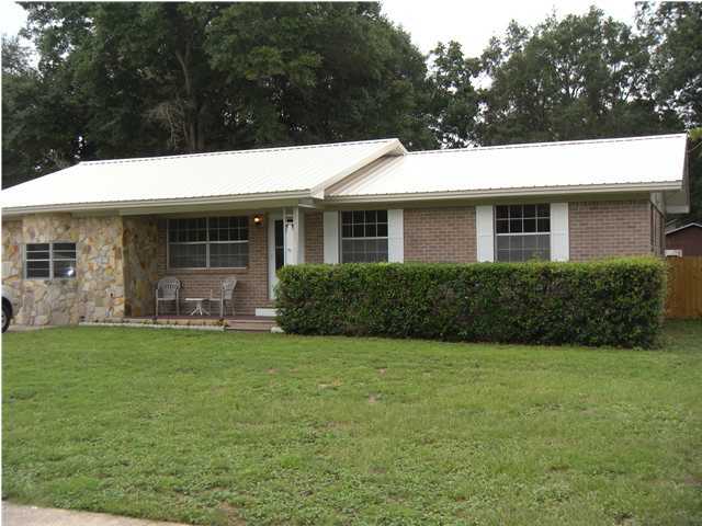 GOLD STAR HOME!! Cute as a button and a one owner home! Walking through the front door you will be welcomed with the original hardwood flooring! This move-in ready home just had a new 60 Year metal roof and newer AC unit installed. Kitchen, dining and living area give way to an open floor plan. The converted single car garage is now a spacious family room with a bay window, new carpet and a side entry door. The large 19.7 x 24 open patio outback will make a great place for a canvas canopy/gazebo to have summer time picnics. The property includes a workshop with power. This home is centrally located south off Palm Blvd. and close enough to walk to Palm Plaza. Seller will consider paying 1/2 of buyers closing costs with an acceptable offer. Seller will provide a 1 year American Home Shield