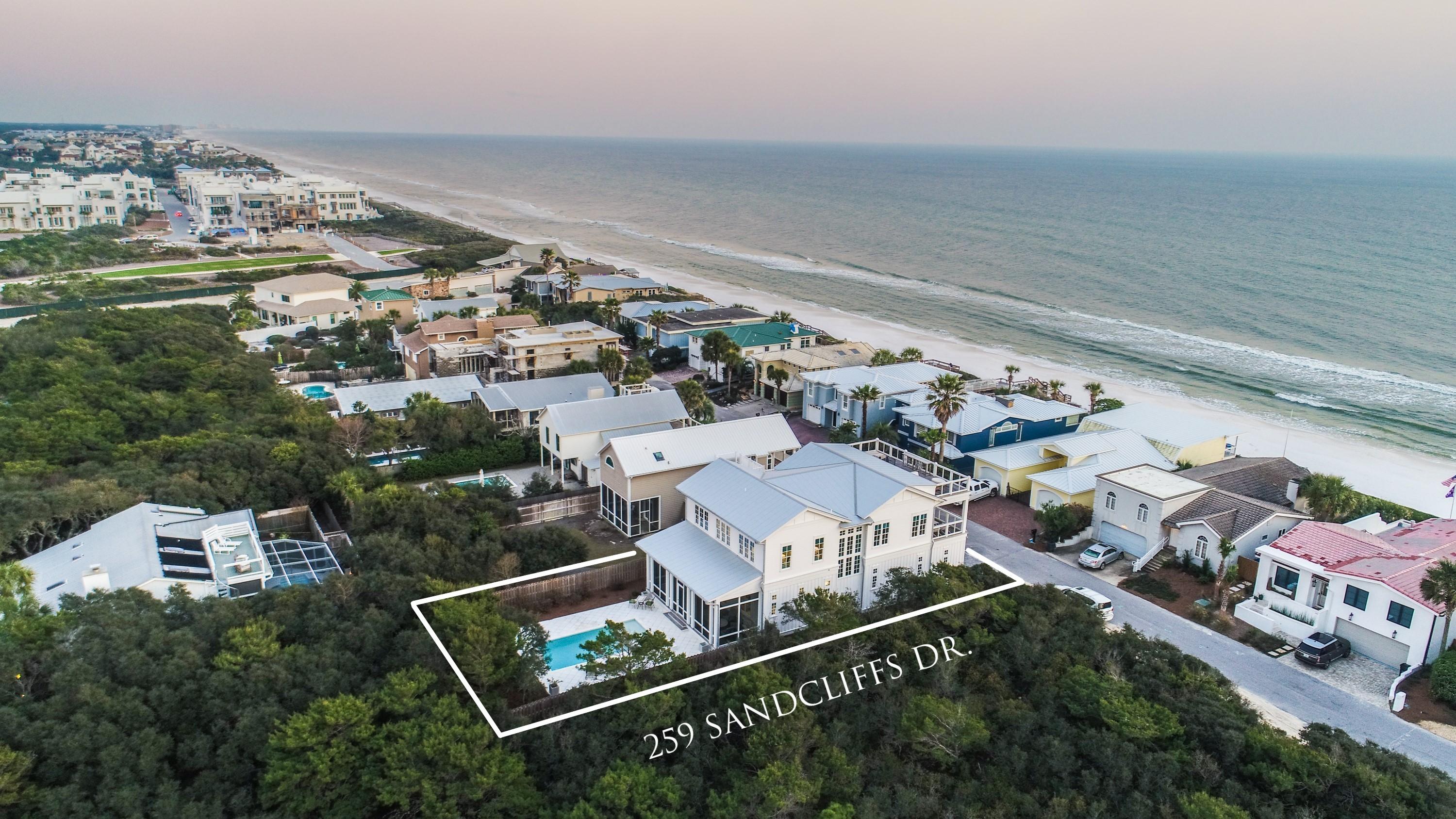 Sequestered in the beachside, gated community of Sand Cliffs, this exquisite Geoff Chick-designed home, offers a rare ownership opportunity one off the Gulf of Mexico. This stunning home, welcomes you through a gated entrance into a tranquil courtyard centered with a European fountain that sets the stage for all the artisan details throughout the home. From a third floor roof top terrace, panoramic views from east to west set the stage for a lifestyle of luxury and quietude. This gracious 3,005 sq. ft. home boasts 4 bedrooms, 3.5 baths, and richly appointed interiors with custom designer touches throughout. A reverse floor plan with expansive windows spills an abundance of natural light into the home and frames views of the Gulf. Over-sized two car garages present over 2,400 sq ft with