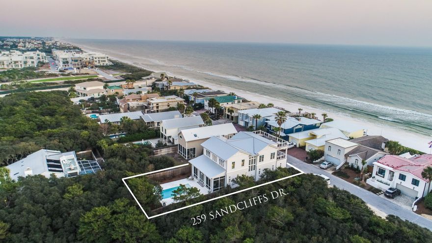 Sequestered in the beachside, gated community of Sand Cliffs, this exquisite Geoff Chick-designed home, offers a rare ownership opportunity one off the Gulf of Mexico. This stunning home, welcomes you through a gated entrance into a tranquil courtyard centered with a European fountain that sets the stage for all the artisan details throughout the home. From a third floor roof top terrace, panoramic views from east to west set the stage for a lifestyle of luxury and quietude. This gracious 3,005 sq. ft. home boasts 4 bedrooms, 3.5 baths, and richly appointed interiors with custom designer touches throughout. A reverse floor plan with expansive windows spills an abundance of natural light into the home and frames views of the Gulf. Over-sized two car garages present over 2,400 sq ft with