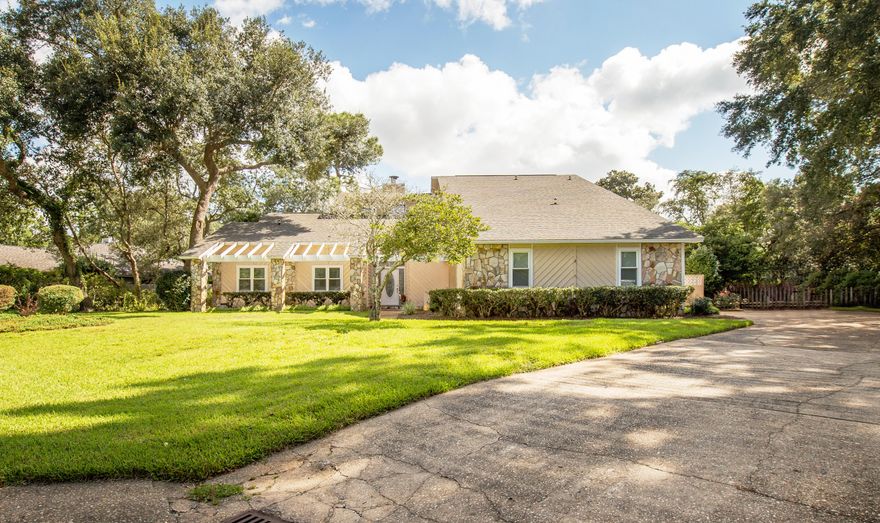 EXCEPTIONAL HOME! Beautifully updated and meticulously maintained family home in gated Windward community of Bluewater Bay. Home features two master bedrooms, one on 1st floor and one on 2nd. The entire 2nd floor is a master suite which includes large bedroom, sitting area and balcony, 2 huge walk-in closets (10X7 & 12X8), dressing area, large master bath (shower, toilet and tile floors replaced 2014), and computer/craft room across catwalk. Upstairs bamboo flooring and wood stairs replaced 2012. Remodeled gourmet kitchen features cabinets w/pull out shelves, granite counters, stainless appliances, two pantries. There are two living areas, formal dining room, wood burning fireplace, wet bar, LOTS of storage. Downstairs flooring is all tile except carpeted bedrooms. Truly a MUST SEE!