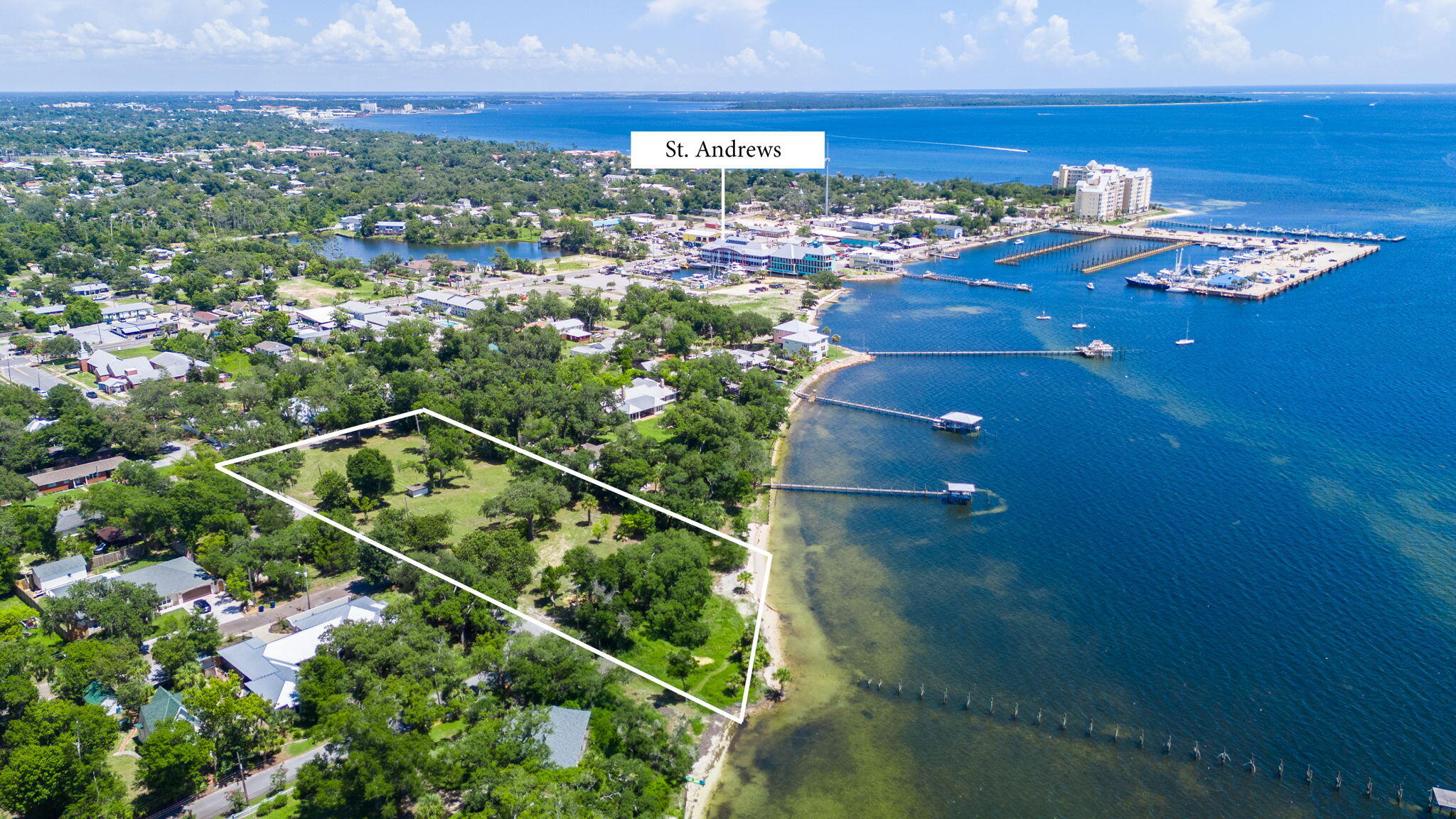 Discover a truly RARE and remarkable opportunity to own just under 2 acres of pristine WATERFRONT property in the heart of Historic St. Andrews--one of Panama City, Florida's most coveted and charming neighborhoods. This 1.9-acre bayfront estate lot offers an extraordinary canvas for your dream home or private retreat, with sweeping views of St. Andrews Bay, mature oaks, and unmatched privacy rarely found in such a prime location. Positioned at the end of a quiet street, this one-of-a-kind property boasts approximately 165 feet of water frontage, offering direct access to the Bay and Gulf--perfect for boating, fishing, paddleboarding, or simply enjoying Florida's coastal lifestyle. With its grand size and natural beauty, this estate-sized lot evokes a sense of serenity while being just moments from the vibrant shops, restaurants, and marina of Historic St. Andrews, and only a short drive to Downtown Panama City and the turquoise waters and white sandy beaches.
Zoned residential and free from HOA restrictions, this is a unique opportunity to create an iconic homestead or luxurious waterfront compound in a location steeped in Old Florida charm. Properties of this caliber and size seldom become available-this is your chance to own a piece of paradise in one of Bay County's most historic and picturesque waterfront enclaves.
Dock permit has been issued for the reconstruction of the existing dock to include a 332' walkway, 3 38' finger piers and a 14' x 38' covered boat slip with lift. This gives endless possibilities for multiple boats at your homesite with pure Bay views!
Imagine leaving your home for Shell Island with the family or early morning for a day of hunting redfish on the flats. Take in the views by watching the most incredible sunsets from your back yard on this stunning property at a high elevation.
This lot may be subdivided into separate parcels. Buyer would need to verify information with the City of Panama City for any potential to divide.
Zoning allows for short term rentals in this area as well as city water and sewer being available.
Discover your dream waterfront homesite in Historic St. Andrews!