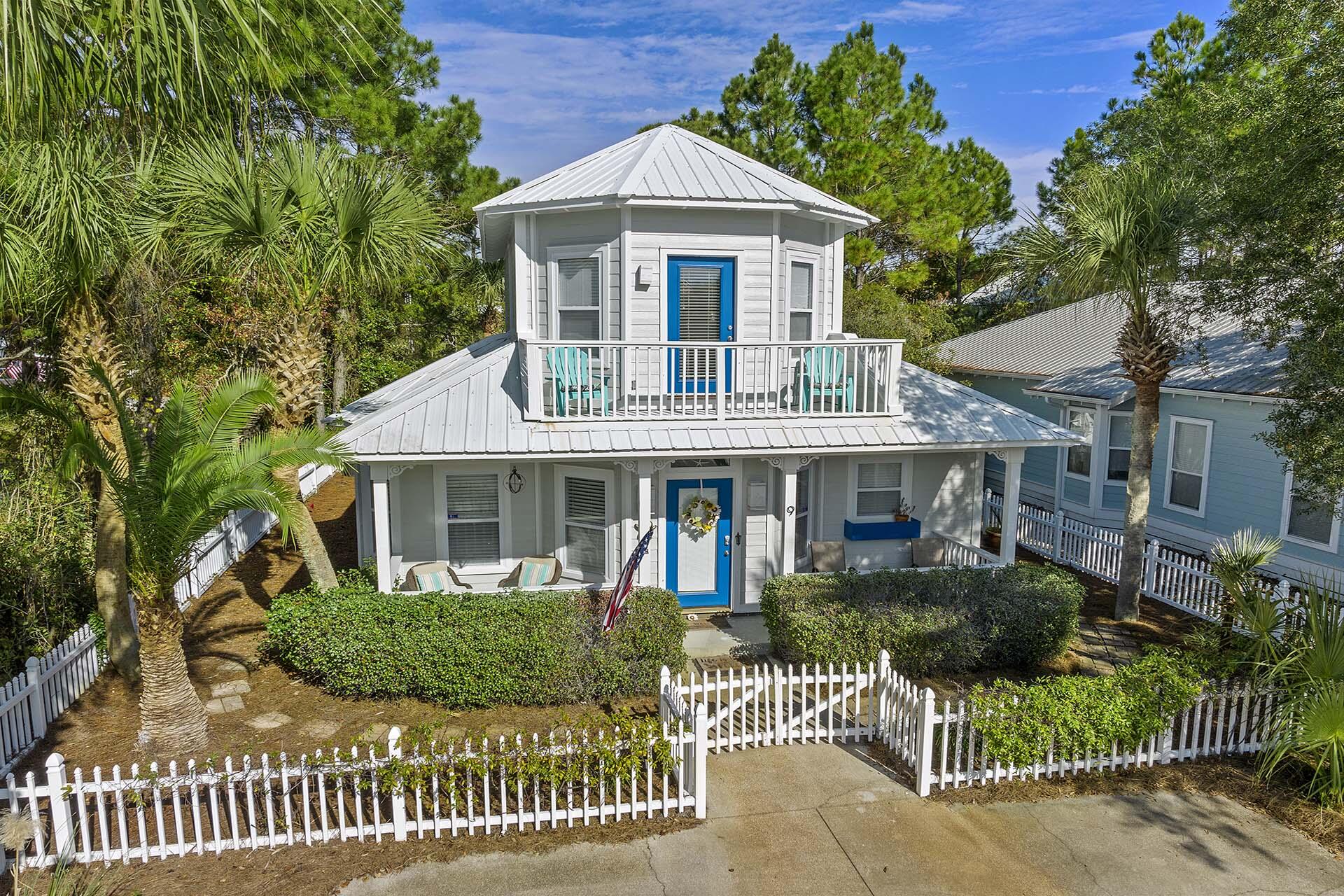 This rental ready cottage in the heart of Seagrove Beach is only a 300 yards walk to the gulf. This 3 bedroom home is offered furnished with only a few small exceptions. The front of the home features a porch on the first level and an observation balcony on the second level. When you enter, the living area opens into the kitchen featuring bright white quartz countertops, and honey-toned hardwood flooring is featured throughout. A charming dining alcove off the kitchen seats four and two more can dine at the kitchen island. All three bedrooms have a full en-suite bath, with two of them on the first floor. The master suite on the first level has vaulted ceilings and the bathroom has double vanities as well as both a tub and a walk in shower. One of the guest bedrooms is downstairs.