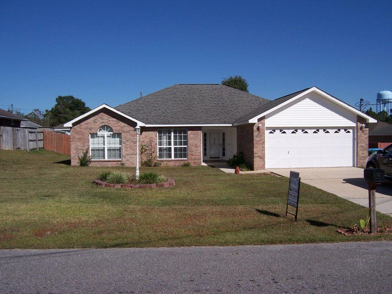 Great Home Located South of I-10 in a nice subdivision, zoned to great schools, with no HOA fees! Just a ten minute drive to Duke Field or Special Forces camp this home has laminate wood flooring in living room, dining room and hallway. The living room features a fireplace and doors leading out to a covered patio and large fenced yard. Primary bedroom with an en suite bath has a separate shower and walk-in closet. The fourth bedroom is attached to the primary suite and could be used as an office, nursery or exercise room, etc. The attractive pricing reflects that the kitchen and bathrooms are original and allows you to make your own cosmetic updates. Take advantage of this opportunity to own a wonderful home in a great location. Come see it today!