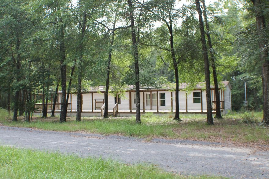 Location Country get Away! Nearly 100 Acres on a County Paved road! Bring the Horses and Log Cabin Plans Today! Lots of deer tracks,Hard Woods, cleared land ready for the recreational get away or Gentleman's farm! Water flows and the stars still shine bright from here! Mobile home needs work but a good start or rental !