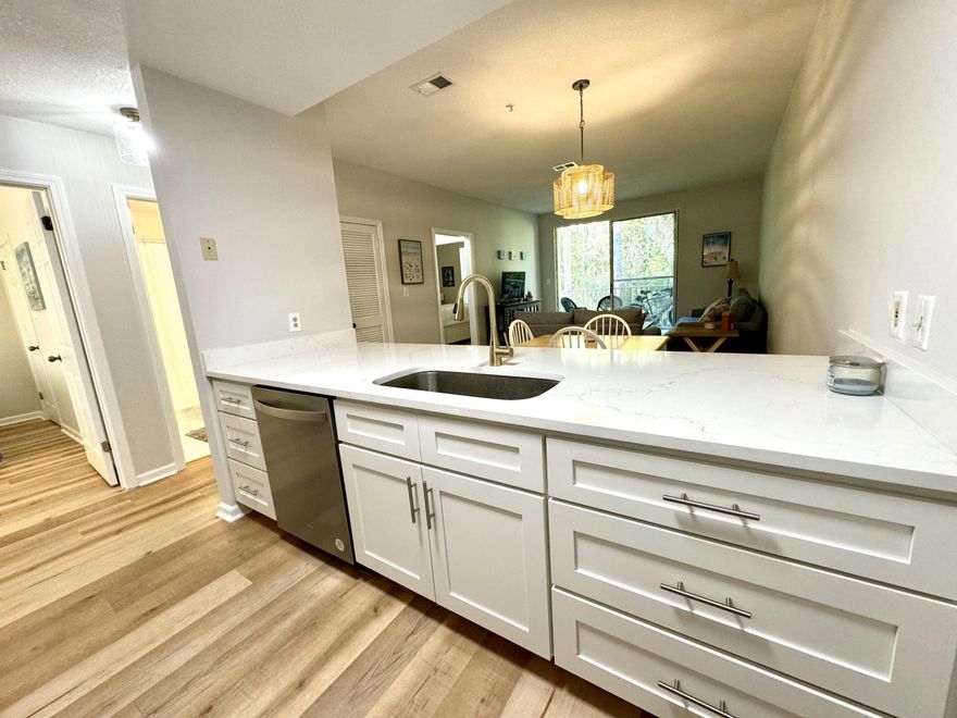 Just Reduced!!! Welcome to Pointe of View. This quaint community is just a short distance to the beautiful 30A beaches and within walking distance to Grand Boulevard Shopping Center that offers Publix, Grand Theater, upscale shopping, dining and much more. This two bedroom, two bath condo is being sold fully furnished, offers 9' ceilings with an open floor plan and has been beautifully renovated with quartz countertops, white cabinetry, brushed gold touchless faucet, stainless steel appliances and garbage disposal in the kitchen, new LVP flooring throughout with tile in the bathrooms, fresh interior paint on walls and ceilings, window treatments, new vanities, mirrors, faucets and toilets in both bathrooms, new washer and dryer, new water heater along with all new glass in windows. The  covered patio  overlooks a serene, wooded area to enjoy morning coffee or evening cocktails and also includes an owner's closet with ample storage. The master bedroom offers his and her closets with an ensuite bathroom. The guest bedroom has a walk-in closet with a jack and jill style bathroom. This community offers a fitness center, large pool, picnic and barbecue area and much more. Grand Boulevard Center just steps away is always having fun events for the entire family from a farmer's market on weekends to parades, festivals and more. Don't miss your chance to live close to it all or to own a wonderful investment property where short- and long-term rentals are allowed. Buyer to verify all information deemed important.