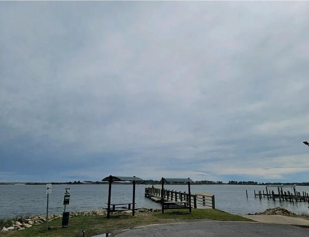 Nestled in Timberlane Estate of Mary Esther, this large vacant lot offers a rare opportunity to build your dream home on one of the last buildable lots in the neighborhood just steps from the water! Encompassing almost a third of an acre, the property includes a cement parking pad, power, water and sewer. This property is the perfect blend of privacy and convenience. Enjoy easy access to nearby amenities, including shopping, dining, and recreational facilities, while still relishing the tranquility and seclusion that this prime location offers. Don't forget the semi public dock at the end of the street with amazing views of the water! The Lot is also very close to the local public schools.