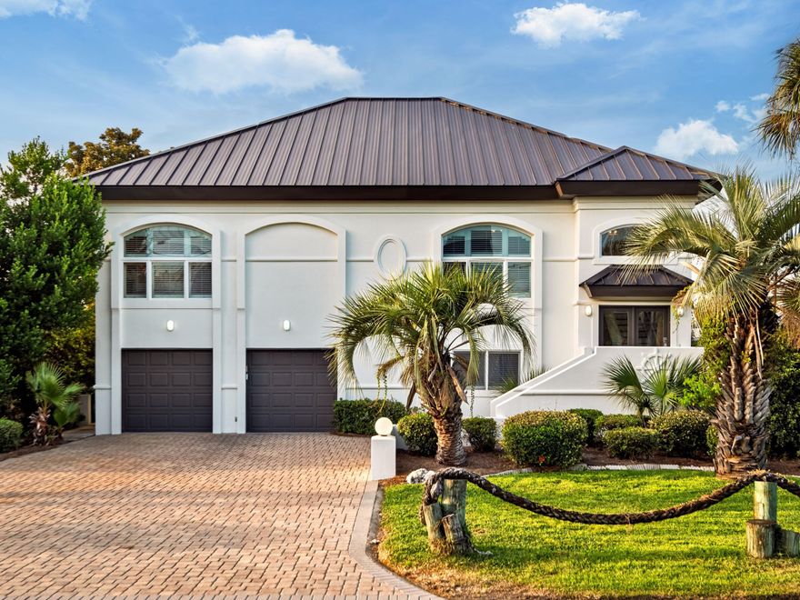 Set along the deep, protected waters of Holiday Isle, this five-bedroom coastal retreat is designed for those who live life on the water. With direct access to Destin Harbor, East Pass, and the Gulf of Mexico, the property features two private boat slips, one with a 20,000-pound lift for a large vessel and the other offering additional wet slip space.Expansive balconies, outdoor terraces, and a sun deck capture sweeping canal, harbor, and gulf views, creating the perfect backdrop for entertaining or unwinding after a day at sea. Inside, the open air living space strikes a balance between comfort and versatility. The main living area is located upstairs, while the first floor offers flexible quarters ideal for guests, a captain's retreat, or a mother-in-law suite

A spacious game room, bright kitchen, and inviting dining areas make gathering effortless, while large windows throughout fill the home with natural light and frame tranquil water scenes. Just one block from public beach access, this residence offers the best of both boating and beach living.

With excellent rental potential and a coveted location on one of Destin's most iconic stretches of waterfront, this property presents a rare opportunity to own a true coastal haven.