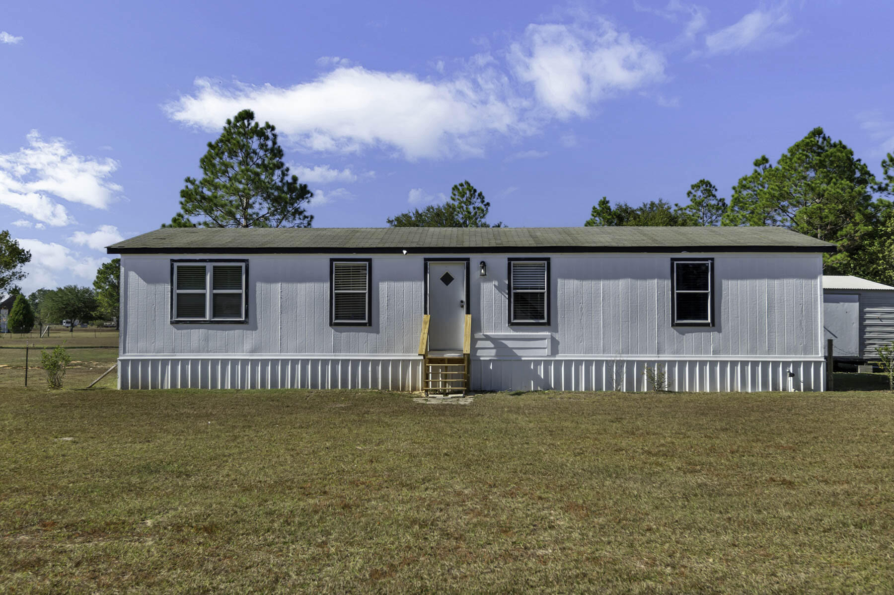 Nestled in the middle of this 2+ acre lot is a newly updated manufactured home that has it all. A turn-key home with 3 large bedrooms and 2 baths with an open concept that will make you feel right at home. Updates include new paint, flooring and light fixtures. Both exterior entrances to the home have updated stairs as well. Hang out on the large back patio or create your own backyard oasis on the huge lot! Don't forget the detached insulated, heated and cooled shed that also has running water, you can turn it into whatever you'd like! Come check it out, you won't be disappointed! Ask about closing incentives with preferred lender and title co.