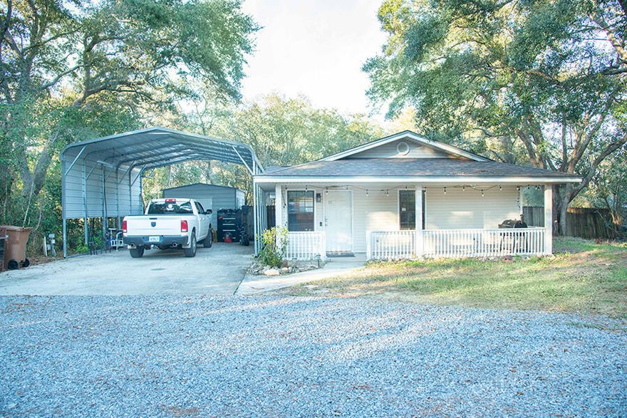 MULTIPLE OFFERS: Best and Final by 7pm Friday. Presenting Saturday Morning.The ONLY house on the market in Navarre at this price. This 2/2 features cathedral ceilings, a sunroom, a large owners suite, open concept floor plan, and a newly remodeled kitchen with new cabinets, stone countertops and stainless steel appliances. The roof is two years old and the primary AC unit is new.The wooded half-acre lot is a handyman's paradise. It features two sheds in the back and a new workshop adjacent to the carport with RV hook-ups as well. This home is perfect for a business owner who needs extra storage and a workshop at home.No HOA. Can be used as a short-term rental.