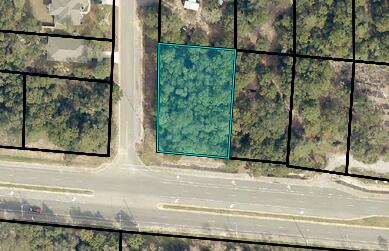 Commercial vacant corner parcel with OWNER FINANCING OPTION.  Lot is on the SE corner of Hwy 87 (with four lanes of busy traffic) and Five Forks Road.  Hwy 87 frontage is 105' x 193' on Five Forks Road (.49 acreage). Zoned HCD (Highway Commercial District) with lots of business options. HIGH & DRY wooded lot - Zone X with easy access from Five Forks Road.  Electric is nearby. Buyer must verIfy all information and specifications.  SURVEY AVAILABLE.Address is approximate and a physical street address will be assigned by Santa Rosa County as part of the building permitting process
