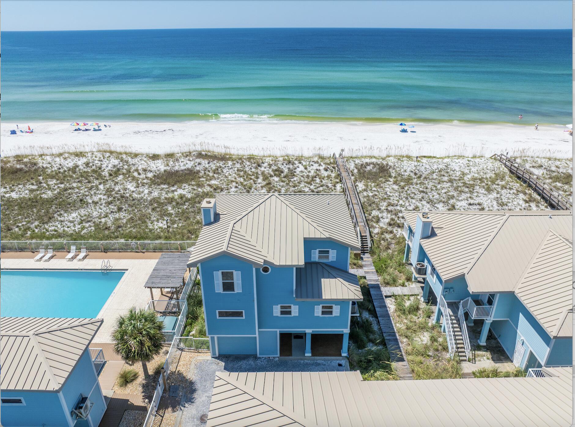 Located in a gated, private community, this Gulf Front 4 bedroom, 3.5 bath condo boasts the best that Pensacola Beach has to offer. Situated at the end of the complex directly on the beach, this property offers all the amenities of a gulf front house as it is secluded and not attached to any other unit, offering full privacy for the owners/tenants. With concrete pilings and floors, ICF construction, hardy board siding, and a standing seam metal roof. With a complete interior remodel, this unit has been immaculately maintained and brought up to the current time. This unit, having only two owners, has never been rented, so utmost design and maintenance care has been taken into consistent consideration. Located in a gated, private community, this Gulf Front 4 bedroom, 3.5 bath condo boasts the best that Pensacola Beach has to offer. Situated at the end of the complex directly on the beach, this property offers all the amenities of a gulf front house as it is secluded and not attached to any other unit, offering full privacy for the owners/tenants. With concrete pilings and floors, ICF construction, hardy board siding, and a standing seam metal roof.
With a complete interior remodel, this unit has been immaculately maintained and brought up to the current time. This unit, having only two owners, has never been rented, so utmost design and maintenance care has been taken into consistent consideration. The large ground floor garage can accommodate two full size cars and plenty of storage. There is an elevator accessing all three floors with glass panels on either side offering incredible views of the gulf as you are ascending. The eat in kitchen features a large quartzite island and an abundance of countertop space to cook and entertain. Flowing off the kitchen is the large open dining and living room featuring large gulf front windows flooding the room with natural light. Off the kitchen is the half bath and first gulf front junior master with ensuite bathroom and balcony access. Up the cable rail staircase is the remaining three bedrooms and bathrooms. The North bedroom is a large room with views of the sound and the newly added South bedroom features a large closet with built in cabinetry and large windows to the gulf. Both rooms have access to the shared hall bath featuring a large tub with tiled surround. The master suite features a private balcony and a large bathroom with walk in shower, separate toilet room, double vanity, and two large walk-in closets. Additional features include newer HVAC units and water heaters, hot water heater boosters, and automated/voice activated controlled lights, blinds, etc. Being offered fully furnished, come tour today!