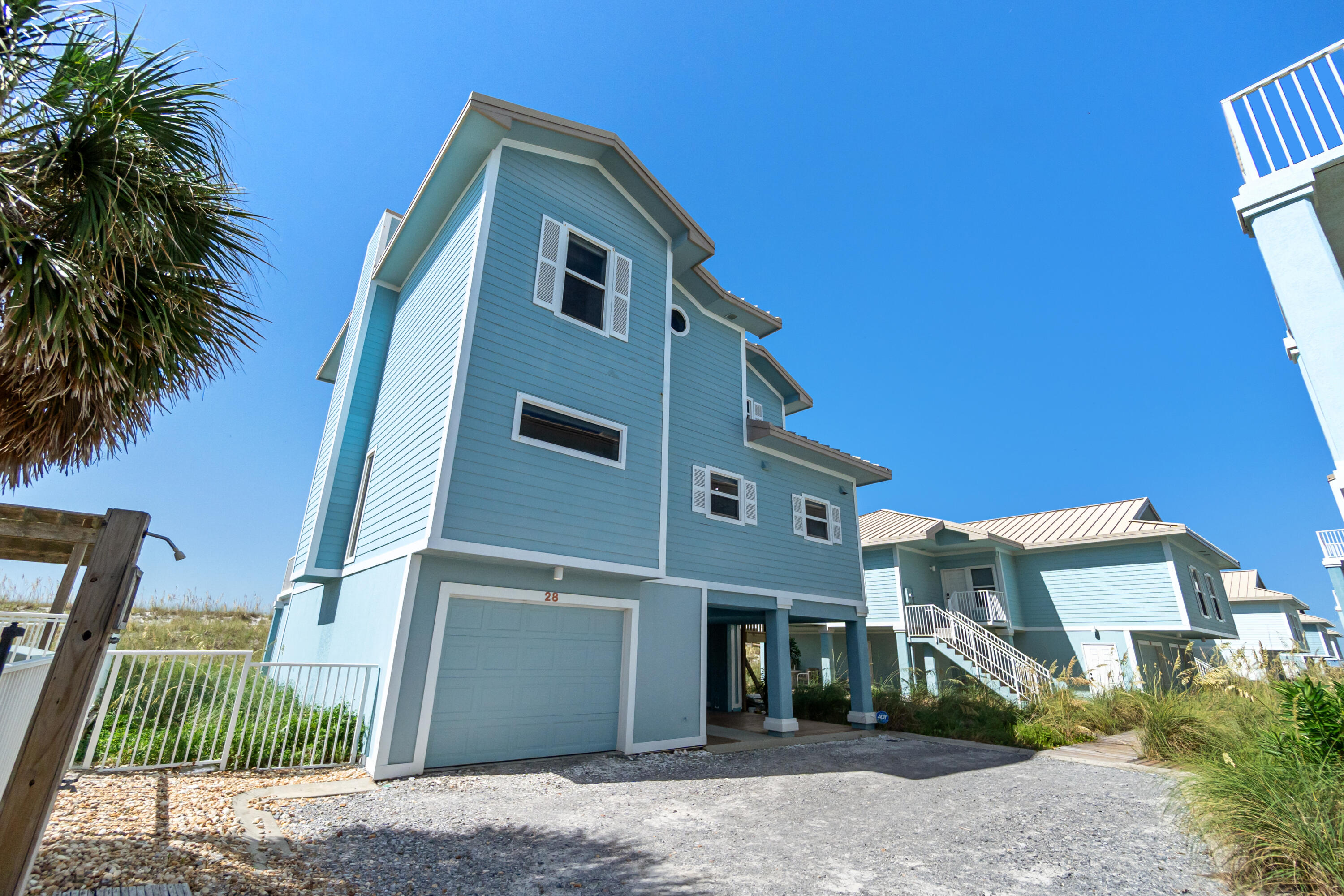 Located in a gated, private community, this Gulf Front 4 bedroom, 3.5 bath condo boasts the best that Pensacola Beach has to offer. Situated at the end of the complex directly on the beach, this property offers all the amenities of a gulf front house as it is secluded and not attached to any other unit, offering full privacy for the owners/tenants. With concrete pilings and floors, ICF construction, hardy board siding, and a standing seam metal roof. With a complete interior remodel, this unit has been immaculately maintained and brought up to the current time. This unit, having only two owners, has never been rented, so utmost design and maintenance care has been taken into consistent consideration. Located in a gated, private community, this Gulf Front 4 bedroom, 3.5 bath condo boasts the best that Pensacola Beach has to offer. Situated at the end of the complex directly on the beach, this property offers all the amenities of a gulf front house as it is secluded and not attached to any other unit, offering full privacy for the owners/tenants. With concrete pilings and floors, ICF construction, hardy board siding, and a standing seam metal roof.
With a complete interior remodel, this unit has been immaculately maintained and brought up to the current time. This unit, having only two owners, has never been rented, so utmost design and maintenance care has been taken into consistent consideration. The large ground floor garage can accommodate two full size cars and plenty of storage. There is an elevator accessing all three floors with glass panels on either side offering incredible views of the gulf as you are ascending. The eat in kitchen features a large quartzite island and an abundance of countertop space to cook and entertain. Flowing off the kitchen is the large open dining and living room featuring large gulf front windows flooding the room with natural light. Off the kitchen is the half bath and first gulf front junior master with ensuite bathroom and balcony access. Up the cable rail staircase is the remaining three bedrooms and bathrooms. The North bedroom is a large room with views of the sound and the newly added South bedroom features a large closet with built in cabinetry and large windows to the gulf. Both rooms have access to the shared hall bath featuring a large tub with tiled surround. The master suite features a private balcony and a large bathroom with walk in shower, separate toilet room, double vanity, and two large walk-in closets. Additional features include newer HVAC units and water heaters, hot water heater boosters, and automated/voice activated controlled lights, blinds, etc. Being offered fully furnished, come tour today!