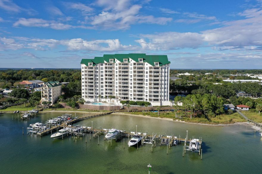 Enjoy magnificent views of the Destin harbor, pass and Gulf of Mexico from this 6th floor most western unit of Grand Harbor.  From the privacy of your own balcony, the master bedroom and the main living area, you can watch the gorgeous sunsets year round,  fireworks from the pass every Thursday evening and holidays, watch the boats and harbor wildlife that includes dolphins, pelicans, different birds and the occasional manatee.  Luxury features of the unit include 9.5 foot ceilings, floor to ceiling windows, gorgeous travertine flooring, granite countertops, large walk in closets, and a double sided gas fireplace for ambiance.  Grand Harbor is rental restricted to a minimum of 6 months and the development also has the convenience of a traffic light for easy access to 98.