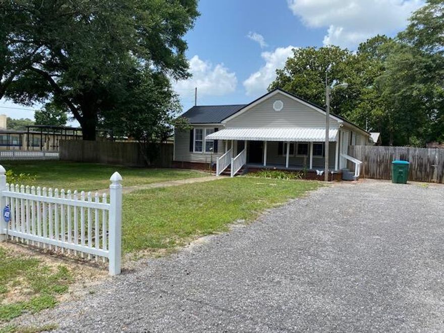 Quiet but convenient location near schools, hospital and shopping.  Remodeled home (2011) that features many upgrades done in the last TWO years (2020-2022): On demand hot Water Heater, 200 Amp panel & mast, new GFI outlets, gas stove, side by side refrigerator, washer & Dryer, Electric gate for carport, new flooring all adds to the modern, comfortable appeal, of this home.  Front and back yards have programable irrigation system on its own water meter, separate from the house meter. Beautifully landscaped yard featuring mature trees and plants. The screened Back deck has outdoor kitchen setup for easy entertaining. The 30X14 workshop is insulated with power.