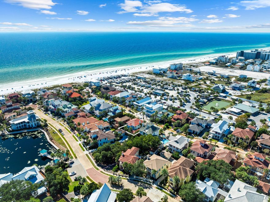 Just a few lots from the beach, this Caribbean inspired home in the sought-after gated community of Caribe West offers coastal living at its finest. Located south of Highway 98, the property sits behind a lushly landscaped, fenced yard and invites you in with a welcoming covered front porch, framed by three sets of French doors that open from the main living area.Inside, the open concept layout is full of natural light and charming details like plantation shutters, crown molding, and elegant column accents. Cool tile flooring runs throughout the main level, connecting the kitchen, dining, and living spaces seamlessly. The living area features a cozy gas fireplace with a 'living flame' effect, perfect for quiet evenings or entertaining.The kitchen is both stylish and and functional, centered around a large island with a glass cooktop and stainless steel vent hood. A double farmhouse sink, stainless steel appliances, and marbled countertops add to the coastal charm. The peninsula breakfast bar provides the perfect spot for casual dining or serving guests.

Upstairs, a split landing leads to spacious bedrooms with beautiful hardwood floors. The primary suite includes access to a private balcony and a serene en suite bath featuring shiplap walls, a double vanity, and a whirlpool tub for relaxing soaks. The second floor also includes a full-width covered porch - deal for sipping morning coffee or enjoying an ocean breeze with a tropical drink in hand.

Out back, the elevated deck and shady arbor create a peaceful space for grilling, entertaining, or simply unwinding outdoors. And with private beach access just yards away, the location couldn't be better for a vacation getaway, second home, or rental property.

Additional highlights include a paved driveway with covered carport, two community pools, tennis courts, and a pavilion for residents and guests. Short-term rentals are allowed (7-day minimum), offering income potential while preserving the neighborhood's charm. Recent updates like a newly replaced roof and tankless hot water system mean this move-in-ready beach home checks all the boxes.
