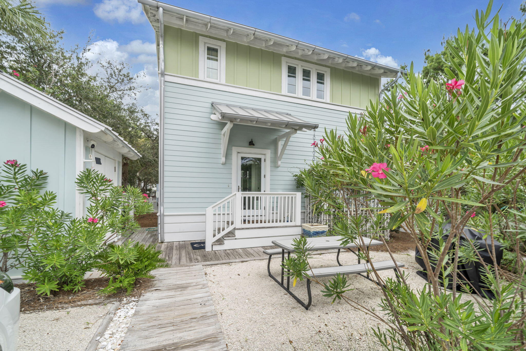 Carillon Beach, a private community on the Gulf. This two bedroom guest cottage has been upgraded and has a great rental history. Each bedroom has a private bath and outdoor deck. Just steps to the beach crossover and almost one mile of uncrowded white sand beach. The property has been approved for a main house on one of the best interior lots in Carillon. If you plan to build, this may be a great way to have a place at Carillon while planning on your dream home.