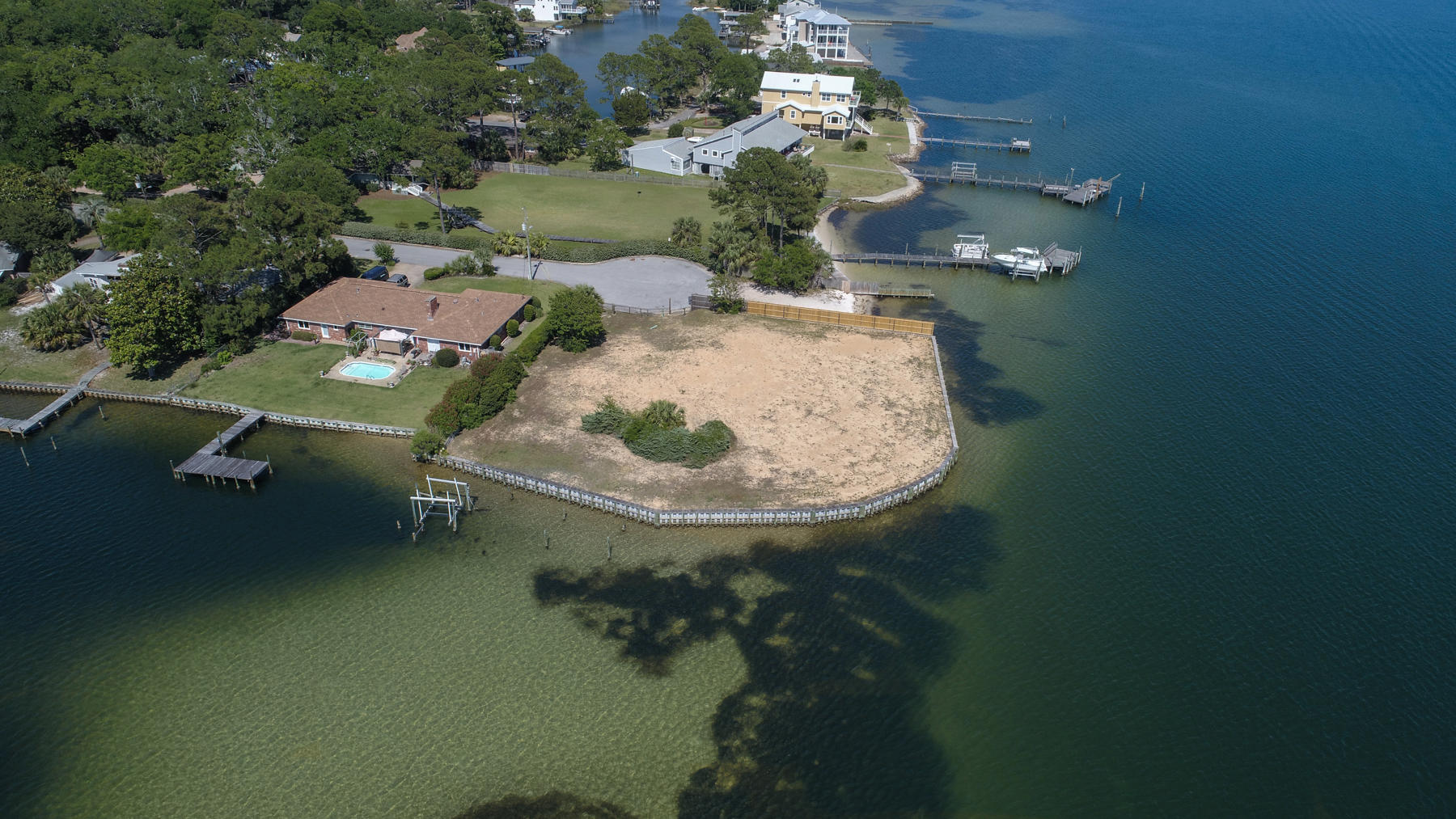 Are you looking for the prize waterfront lot in Fort Walton Beach or along the Emerald Coast of Florida? This stunning lot off Brooks Street has three sides on the water - over 280 feet of water frontage. Imagine the panoramic views from your new home's balcony! Imagine the wind in your hair! Imagine the home of your dreams! This Brooks Street area waterfront lot has a new 6' seawall and fence. Your views are up and down the coastline, seeing the fireworks on display at night, the Brooks Bridge! Half-acre building site is cleared, tap fees are paid and new survey complete. We have a builder for you.