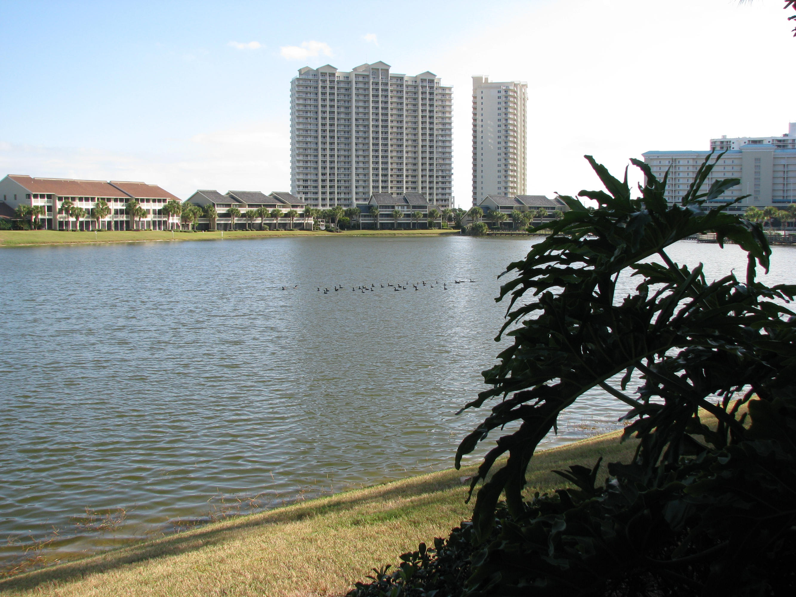 LOCATED NEAR CROSSOVER AT WHALE'S TAIL RESTAURANT AND ON THE SOUTH SIDE OF STEWART LAKE. UNIT HAS OVERSIZED MASTER BR ON LAKESIDE AS WELL AS LIVING AREA WITH A DOUBLE PATIO THAT IS SCREENED. SEASCAPE RESORT HAS: 18 HOLE GOLF COURSE, CLAY TENNIS COURTS WITH PRO SHOP, FRESH WATER LAKES, OVER 2000 FT OF DEEDED BEACH ACCESS, 5 POOLS ( 1 HEATED IN WINTER), CONFERENCE CENTER, SEASCAPE'S WHALE'S TAIL RESTAURANT,GATED COMMUNITY & MUCH MORE.