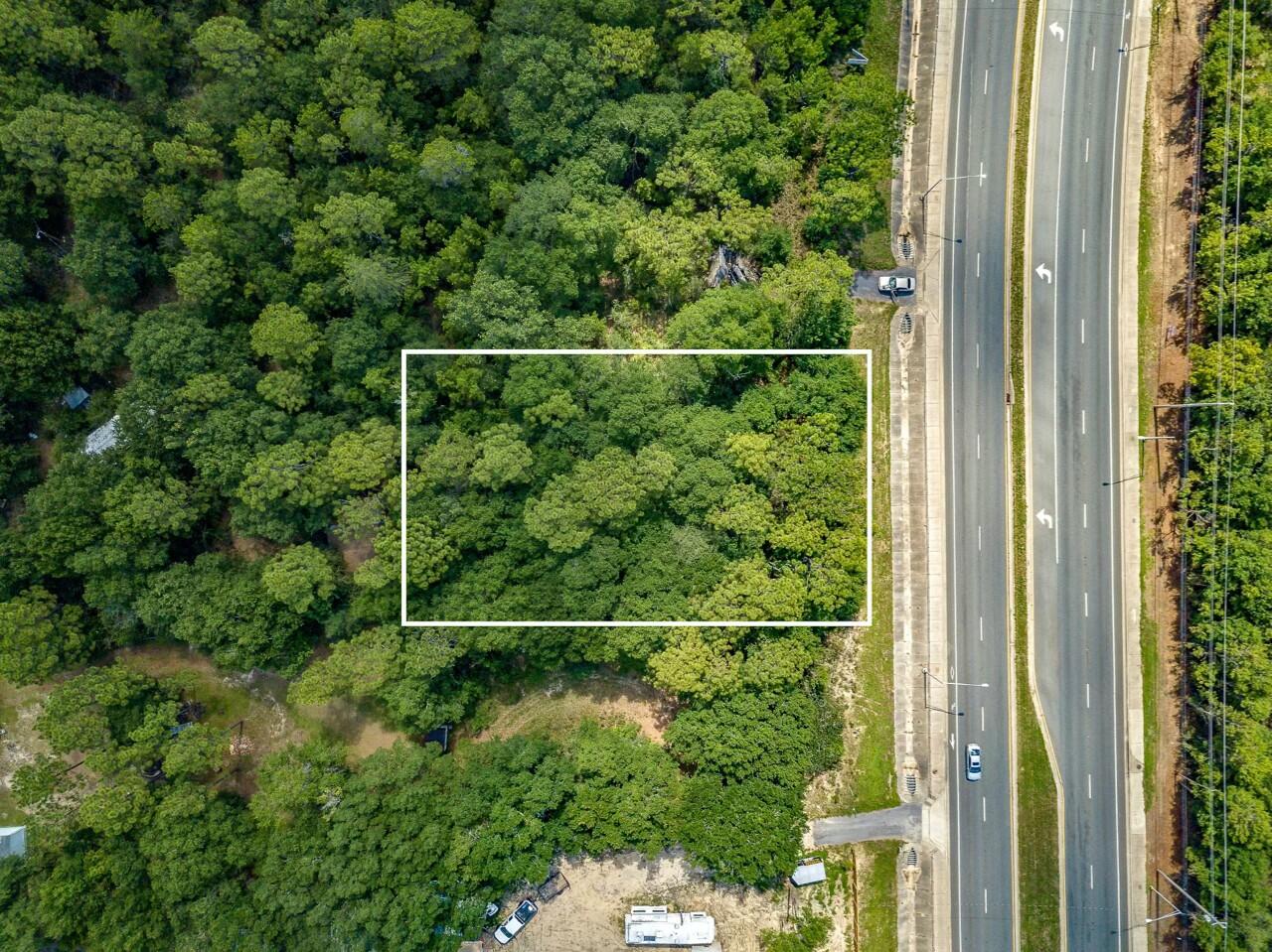 Prime Commercial Lot with 100ft Highway Frontage!! Unlock endless possibilities with this strategically located lot, zoned for commercial use and offering an impressive 100 feet of highway frontage. Situated in a high-visibility area with excellent traffic flow, this property is ideal for businesses seeking maximum exposure. Its convenient highway access allows for easy ingress and egress for potential customers and a steady stream of local and through traffic. This property is ready for your vision to take shape. Whether you're starting a new enterprise or expanding an existing one, this is a great opportunity to secure a premium lot in a thriving location. Navarre and Navarre Beach is one of the last places with the old Florida feel and is home to Florida's Longest Fishing Pier. Enjoy Emerald Green Waters and Miles of Sugar White Sandy Beaches, Walking & Biking Trails, a Fishing pier, Gulf Island National Seashore to the West, and County Owned Park to the East for Additional Activities to Enjoy.