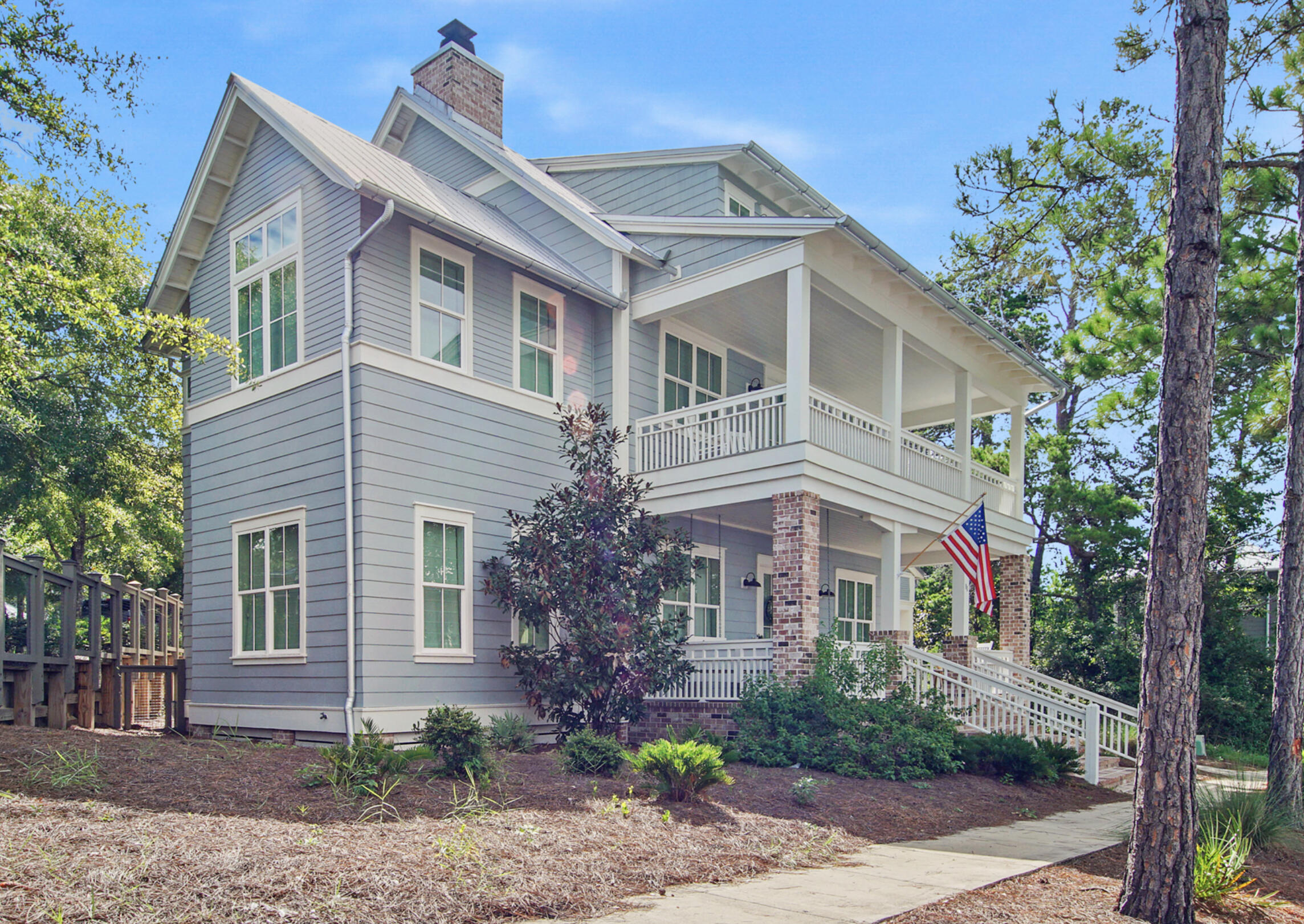 Introducing a custom built, beautifully furnished home in the desirable Forest Lakes gated community on 30A. A 3-story, 5 bed 5.5 bath coastal home sits on a corner lot with a covered parking area, and additional parking on the side street. The elegant brick stairs lead onto a large front porch with double doors opening into an open concept living room featuring a fireplace and a chef's kitchen built for entertainment. The 5th bed/bath is located on the 3rd floor and could be transformed into a game room, office, etc. There is plenty of storage with a climate controlled attic and outdoor storage unit. A screened in back porch and a fenced outdoor area with a gas fire pit is perfect for gathering. Enjoy the walking paths, 2 tiered pool, pavilion, playground, green space and beautiful lake!
