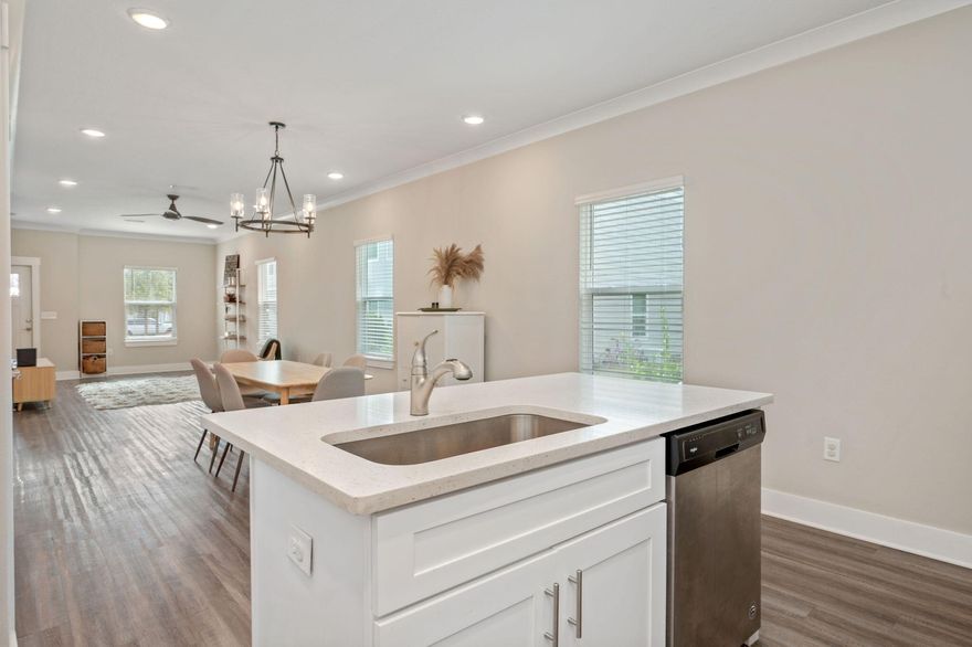 Welcome Home!  Whether you enjoy the outdoors or relaxing inside, this home has it all!  Play outside with your dog, take in the natural greenspace out back, swim in the community pool, play pickleball or basketball, and enjoy the convenience to local amenities and beaches! Relax on your screened in patio and enjoy the serenity of nature in this corner lot!  This Horizon Floor plan is 3BR/2.5 BA with 1396 sq.ft. and an open floor plan with luxury finishes including quartz countertops throughout, stainless steel appliances, LVP flooring in kitchen and living areas, crown molding, a storage/office nook under the stairs, and upgraded light fixtures make this townhome the best priced on the market with the most to offer!