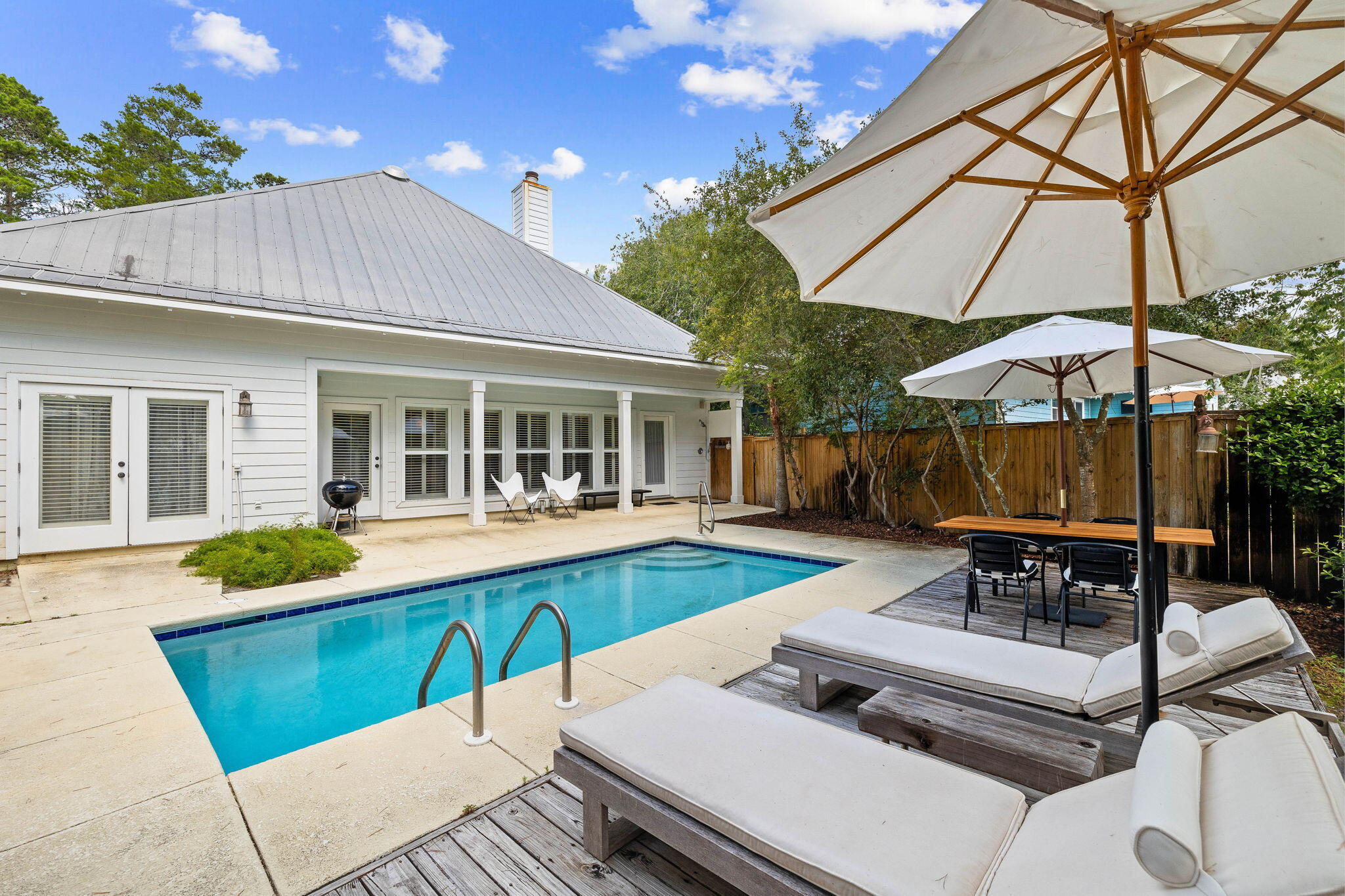 Priced $150,000 under appraised value! Prominently positioned just a few homes back from the turquoise-hued waters on 30A, this charming coastal cottage spans two distinct levels totaling over 2,200 square feet and includes a private pool and deeded beach access. Tucked behind the lush vegetation, an extended driveway leads way to the peaceful screened in porch extending the full width of the house offering a serene and private setting. Upon initial approach inside, the heart of the home unfolds offering a sophisticated living space meticulously designed for both relaxation and entertainment. This is a short term rental neighborhood, but has only been rented long term over the past 10 years.