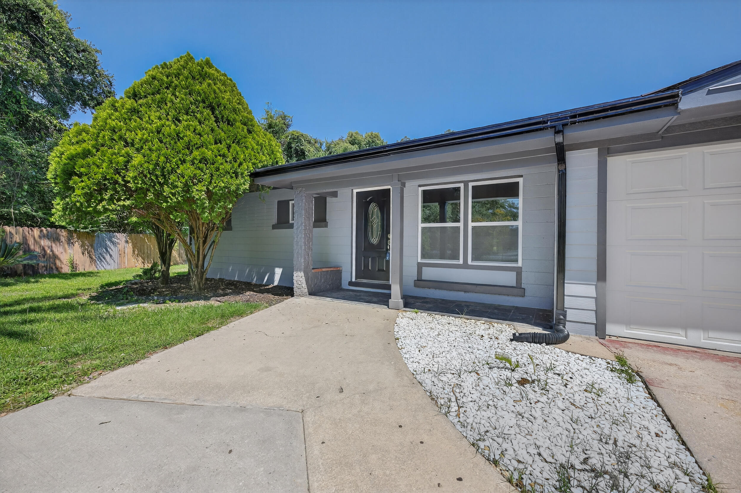 Recently remodeled and move-in ready, this spacious 7-bedroom, 4-bathroom home offers over 2,700 square feet of modern comfort with no HOA restrictions! Major updates include a brand-new 2025 water heater and 2025 HVAC system. Featuring LVP and tile flooring throughout, the home showcases a neutral palette that's stylish and versatile. The kitchen boasts stainless steel appliances and sleek white cabinetry. Just off the kitchen is the dining room, where a cozy fireplace creates the perfect setting for memorable meals. The bright living room offers a comfortable gathering space with an additional nook that could serve as a second dining area. The expansive primary suite is a true retreat, complete with a large closet and a beautiful en suite bathroom featuring a jetted tub, tiled standing shower, and dual vanities. A second bedroom also includes its own private en suite, giving you two true primary suites! One bedroom has both a private entrance from the garage and access through the main home, making it ideal for guests, extended family, or a home office. Outside, the open patio is covered by mature trees to provide a relaxing backdrop, while a shed adds extra storage. The driveway offers parking room for multiple vehicles, a boat, or even an RV. Conveniently located just off Olive Road, you'll be only 15 minutes from downtown Pensacola and close to I-10 for easy commuting. Move-in ready and full of thoughtful updates, this home blends space, function, and convenience in a central location!