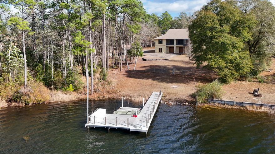 Nestled on nearly 2 private acres with 131 feet of lake frontage, this 5,184-square-foot home in popular Spring Lake Estates is a rare find. Constructed with ICF (Insulated Concrete Form), often called 'hurricane proof' with 2,592 SF of living space on the main level--and an equally large, climate-controlled unfinished walk-out basement--this property offers room to spread out, relax, and dream. Whether you're envisioning multi-generational living or additional entertainment space, the 2592 SF basement provides that flexibility. The main level features 3 beds/2 baths in a split floor plan. An open-concept kitchen flows seamlessly into the living room and includes a large island, a massive walk-in pantry/utility space with washer and dryer. Flanking the foyer are two versatile rooms perfect for a home office, formal dining, or other creative uses (possible 4th bedroom). The master suite, one additional bedroom and the open kitchen/living all enjoy sweeping lake views across the entire back of the home. The master bath is a retreat in itself, with a cultured marble shower, jetted tub, double vanity with abundant storage, and a huge walk-in closet. Two additional bedrooms share a Jack-and-Jill bath for added privacy and convenience. One of the most unique features is the screened-in area on the back porch. With walls and roof fully screened, this space immerses you in panoramic lake views. With 131 feet on the water, the sunset views are simply phenomenal. The dock with Trex decking offers your own private fishing spot or just another place to enjoy the views. The property is gated and is fenced in its entirety (along the water as well) to keep your furry friends safe. There is even a separate smaller fenced area off the back porch where you can let them out as well. Additional features include a two-car garage within the basement, a separate storage building, a whole-house generator, and the impressive structural integrity for peace of mind. ICF construction's durability is unmatched. It is known for it's strength against storms, hurricanes, tornadoes, fire, termites/pests and an added bonus, is extremely energy efficient (seller says average utility bill is $200!). The climate controlled basement is a true shining feature of this exquisite property, featuring a combination kitchenette and bathroom, making it an ideal canvas for finishing it out. Spring Lake Estates is a small community of homeowners who enjoy a quiet, peaceful way of life. If you've always wanted to feel like you're on vacation every day, then please don't miss seeing this very special property!