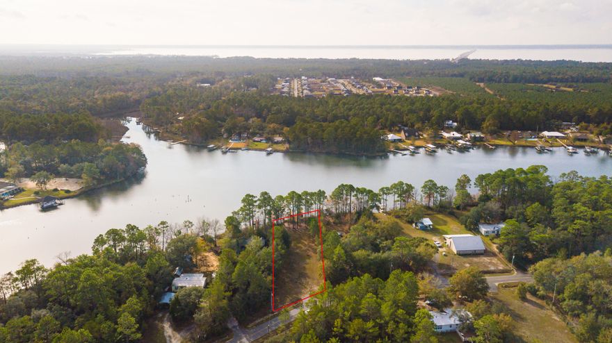 CLEARED LOT WITH DOCK ALREADY IN PLACE. WATERFRONT TUCKED AWAY WITH NATURE ALL AROUND . WATER FRONT IS JUST SHY OF 80FT. GREAT FISHING, BOATING AND CANOE SPOT. COME BUILD THAT DREAM HOME. JUST 20 MINUTES TO THE GULF COAST. THIS IS PRICED TO MOVE AND WILL GO FAST. WATER TAP FEES PAID. PROPERTY WILL REQUIRE SEPTIC SYSTEM.