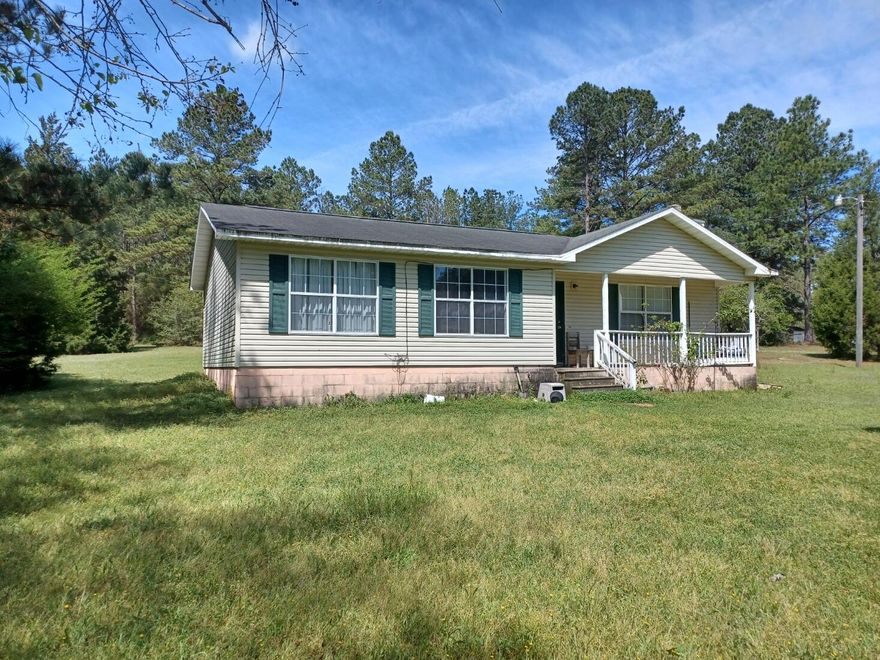 ARE YOU READY FOR YOUR LITTLE PIECE OF PARADISE?? Under 200K with almost 3 acres!What's not to love here? Enjoy country living and still be less than an hour to the Emerald waters and sugar sand! Relax in your quiet surroundings from your front porch while you sip a cool drink or your morning coffee and watch the deer, birds and other wildlife plus all the beauty that nature offers up. With this much land you can have your own garden, special projects or start that workshop you always wanted.This move in ready home also has a ''like new ''wood burning fireplace for those cool evenings that we all enjoy so much.With very little TLC make this your special place!  In Homes County Schools.Buyer to verify all details. Call your favorite Realtor today to schedule viewing.