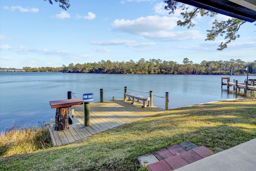 Great one story waterfront Townhome has been well kept.  Walk out the backdoor to a covered patio and dock right on Tom's Bayou.  To the right of the small dock there is also a boat dock with a covered boat lift that is included.  New HVAC and Water Heater in 2021, new roof installed in 2015.  Porcelain Tile Flooring throughout the home.  Master suite has a large walk-in closet and a beautiful view of the water.  A beautiful, spacious kitchen with tons of cabinet space and a large breakfast bar.  You can also enjoy the amenities of Hidden Cove to include a community pool, fitness center and the clubhouse that can be rented for private functions.
