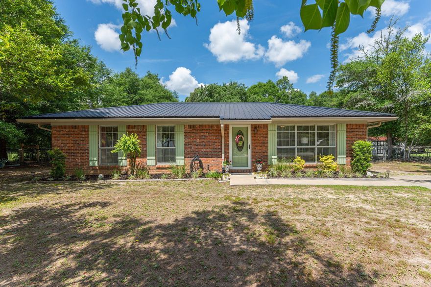 Amazing all brick home in **pristine** condition! Originally built by Tew Construction, local custom builder and built to last. This gorgeous property is sure to appeal to the most price conscience Buyer, w/wonderful updates and incentives in place ($5k credit to Buyer Closing Costs + home warranty). METAL roof installed in 2022 & further improved upon w/whole house gutters.Low maintenance LVP flooring is found throughout all living areas, tile in kitchen/bath/laundry. Countertops, cabinets, light fixtures, vanities, water heater, HVAC, and electrical panel have ALL been updated. The very impressive kitchen includes double ovens, backsplash,SS appliances.Flat nearly 1/2 acre lot is surrounded by mature trees and includes a carport, pergola covered concrete pad/seating area, & additional