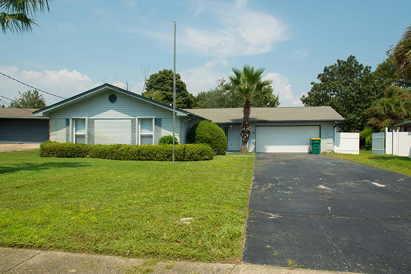 Cute home that needs some TLC. 3 bedroom , 2 bathroom and 2 car garage.  Laminate and tile flooring throughout.  Large living room with wood burning fireplace and built in cabinets. Large screen porched on back of home. Galley kitchen.  Home is being sold As-Is and is priced accordingly. Owner will make no repairs.