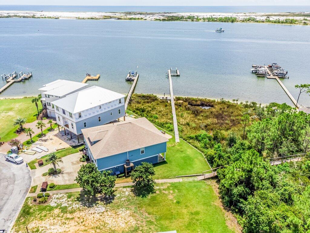 BEACHFRONT HOME!! BEST PRICED SOUND/INTRACOASTAL HOME!! WITH BEACH & PRIVATE DOCK- SUNSET VIEWS GREENSPACE-VIEW WILL NEVER BE OBSTRUCTED! FLOOD INSURANCE $700 YR. Boat slip& Lift, 2 jet ski lifts.!!! Less than 5 Mins to Hurlburt Field, Publix, Walmart, Target!! IMMACULATE RAISED RANCH.4BD & 3BAS. HUGE 4 CAR GARAGE, NEW HIGH EFFICENCY HVAC, OPEN FLOOR PLAN.2500 SQ FT OF GARAGE SPACE. 10 FT INTERIOR CEILINGS, TANKLESS HOT WATER, GAS OR ELECT RANGE, HIGH EFF APPLIANCES, OUT DOOR GAS FIREPIT, IRRIGATED ZYOSIA LAWN WITH WELL, FRESH EXTERIOR PAINT, GRANITE THROUGHOUT, HURRICANE RATED SOUND SIDE WINDOWS.KITCHEN/LIVING/MAST. OVERLOOK WATER, 3 REFRIG, TILED BATHS, HARDWOOD FLOORS, MASTER CLOSETS/HIS AND HERS WITH SHELVING SYSTEM. HUGE SCREENED BACK PORCH. NO SHORT RENTALS LESS THAN 91 DAYS.