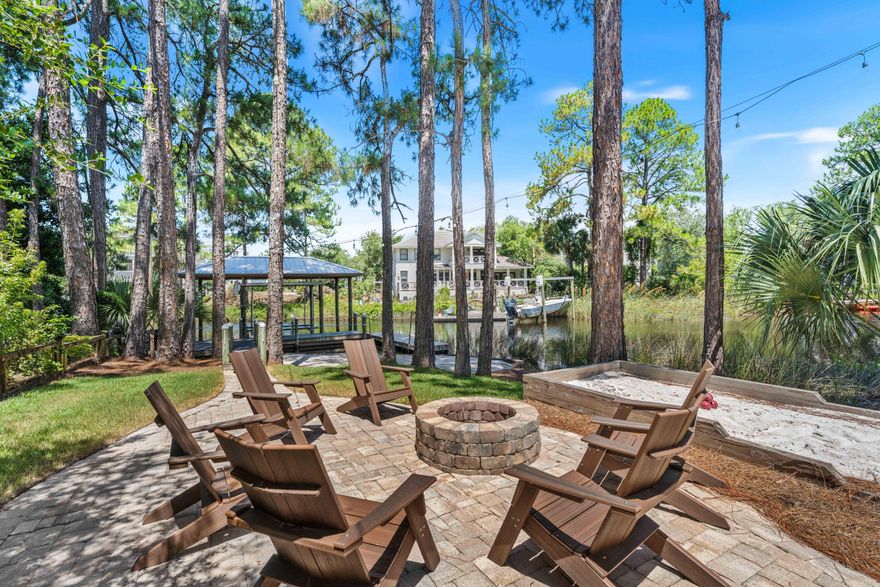 Waterfront Masterpiece! Perched on the peaceful waters of Eastern Lake with panoramic views extending to the Gulf waters, 105 Trae Lane is a true sanctuary with four bedrooms, four bathrooms, and 3,525 square feet of meticulously curated interiors. Spanning four levels featuring elevated craftsmanship, this exceptional residence was completely reimagined in 2022 and offers a rare combination of privacy, waterfront views, and modern sophistication.Inside, no detail has been overlooked. A chef's kitchen is outfitted with top-of-the-line Sub-Zero and Wolf appliances, dual dishwashers, and two ice makers--one is commercial-grade making entertaining effortless. Custom cabinetry with integrated lighting enhances every corner of the home, while other premium features add the touches of coastal creativity. The home's layout includes multiple living spaces and an expansive screened porch, all thoughtfully oriented to maximize views and natural light. Motorized power blinds for the windows on the main level, 100% LED lighting, and two new A/C and furnace units ensure year-round comfort, while a standby natural gas generator, tankless water heater, and state-of-the-art camera and alarm system provide peace of mind.

With two washers and dryers, two climate-controlled garages with additional storage, and thoughtful touches throughout, the home is perfectly equipped for effortless everyday living or multigenerational escapes. This meticulously maintained residence has had only two owners, has never been rented, and remains in pristine condition.
Outdoors, the lifestyle continues with a private boat dock, featuring a covered 5,000-lb boat lift and floating dock ideal for launching kayaks and paddleboards directly into Eastern Lake. From there, cruise straight to the Gulf or explore the serene natural surroundings this unique lakefront location affords.