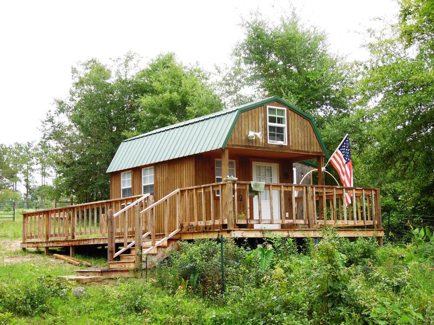 Cabin on Kings Lake- 2.9 acres ...Weekender private...every fisherman's dream of a waterfront weekender cabin, also has ''hook-up: for an RV....perfect for your RV's campsite/home base. Fenced for horses on this 2.9 acres on Kings Lake..waterfront --- complete with 3 pole barns...so bring your horses, pole barns, boat sheds, decks, and dock . Asphalt chip top private on Nellie Paul Road entrance road. So much for such an affordable price.. just plain cozy. Complete with 2 loft beds, full bath, kitchenette complete with refrigerator, microwave, toaster oven, and small stove. Plenty of room to build your dream home above the cabin!