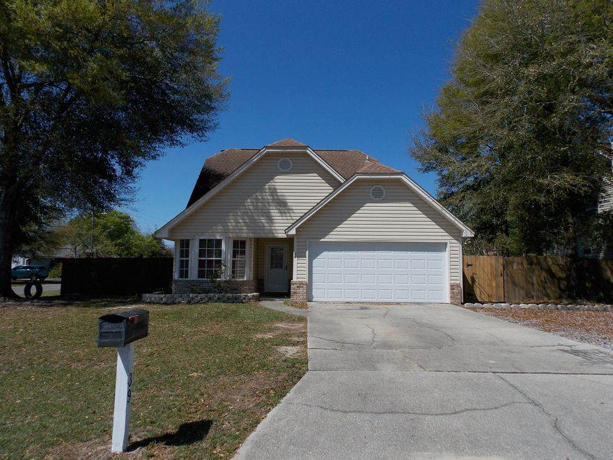 Move-in ready FOUR bedroom/two bath home sits on corner lot in Hollyrod Subdivision, located near hospital, fire-station, and elementary/middle schools. Home boasts durable tile and wood-laminate flooring throughout with carpet in upstairs bedrooms. Master suite has been tastefully updated to include Jacuzzi style tub, tiled separate shower with his and her vanities. The kitchen boasts black granite countertops with updated appliances and window above the sink. Bay window in the eat-in kitchen and brick fireplace in living room adds to this home's charming appeal! Outdoor shed, garage shelving and pull-down stairs to attic give ample storage capability. Yard is fully fenced with single & double-gates, plus the wooden play-set will convey with home!