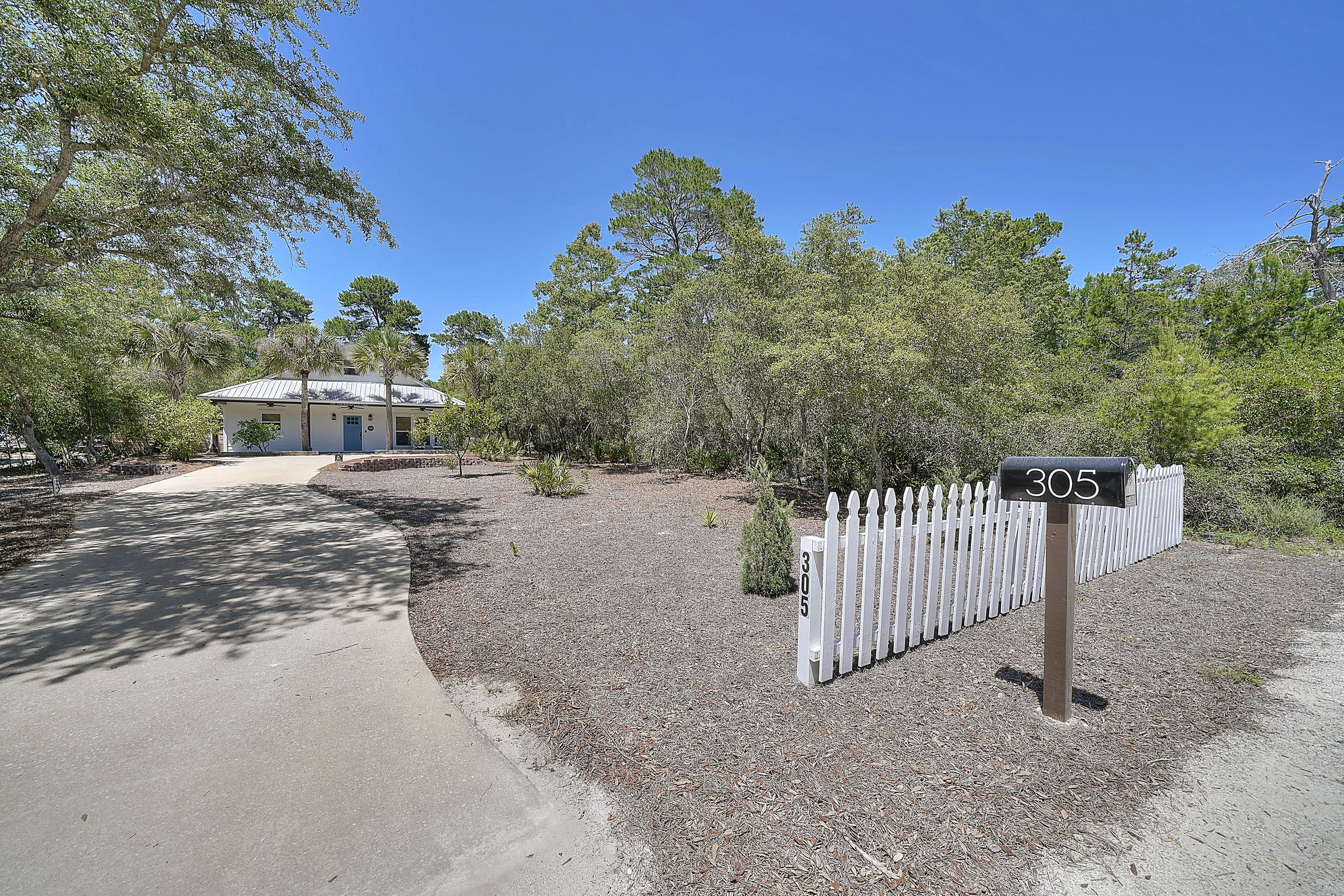 Property has contract in place w/ 72 hour kick-out clause. Land, location and all the modern upgrades combine to make this a ''move-in ready'' beach home. This peaceful 2br/2ba Florida cottage in Inlet Beach sits on a 1/4 acre of land and surrounded by natural palmettos and trees. It's a brief walk the restaurants and shops of 30Avenue, and is a short bike ride to the beach or Lake Powell. This open-concept home was remodeled in the last year and you won't be disappointed by the finer touches you would come to expect in today's construction. Interior features include recessed lighting, LVT Waterproof flooring throughout, quartz countertops in the kitchen and bathrooms, stainless appliances in the kitchen, a new electric HVAC system, a tankless water heater, 9' ceilings with crown molding
