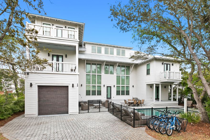 This stunning coastal retreat checks every box: Gulf views, sleeping arrangements for 16, a private heated pool, a garage, great rental income, and no HOA - all just steps from the beaches.Inside, a dramatic three-story window wall floods the home with natural light, setting the stage for relaxed luxury across nearly 3,600 square feet. The open-concept main level is made for entertaining, with a chef's kitchen featuring high-end appliances, a spacious pantry, wine fridge, and a large island that flows seamlessly into the living and dining areas. A private first-floor suite opens directly to the pool, perfect for guests looking for a bit of privacy. You'll also find a convenient half bath, generous laundry space, and direct access to the garage for storing your gear after returning from the beach.

Upstairs, the smart U-shaped layout wraps natural light around every corner. The second primary suite has its own south-facing balcony overlooking the pool, while additional guest bedrooms and a cozy bunk nook provide plenty of room for family and friends. Two more full baths and a second laundry space keep things functional and effortless.

Head to the third floor for elevated Gulf views and a flexible living space. This level features a second entertaining area with a wet bar, full-size fridge, dining table, and lounge seating, plus another half bath and a spacious balcony perfect for catching sunsets.

Sold fully furnished and meticulously maintained, this one-of-a-kind property on 30A is ready for your next chapter  whether that's beach days with the family, investment income, or both.