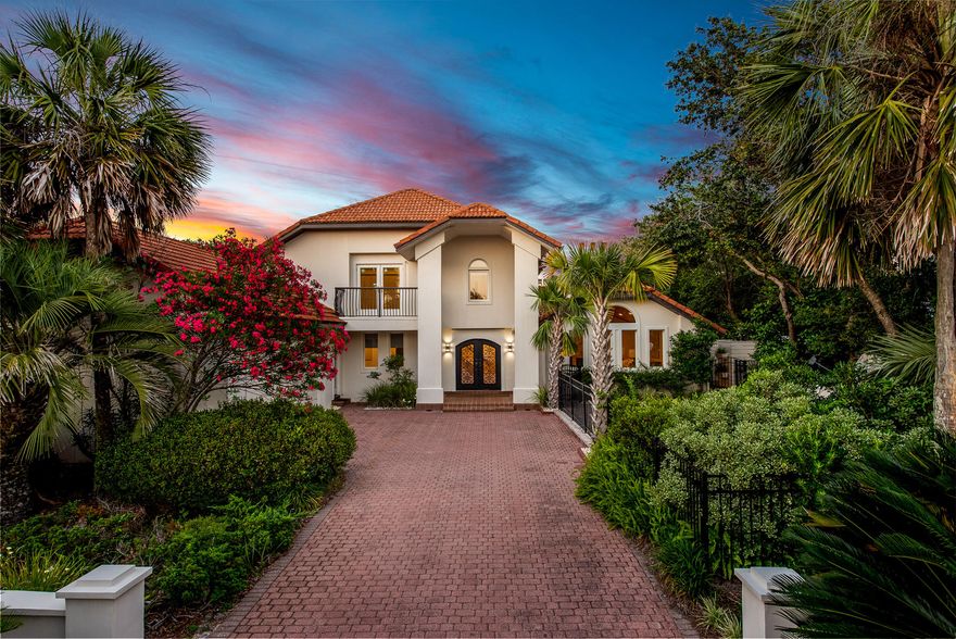 This luxurious custom built Mediterranean style home located south of 30a in the gated neighborhood of Camp Creek Lake. Recently renovated and situated on a large lot, this home spans over 3800 sqft heated/cooled, plus a large outdoor living area that includes a private heated pool with fountain feature, as well as an outdoor fireplace and grill. You are welcomed into this home through a pair of stately glass and iron doors that open to a spacious living area with vaulted ceilings. This room is centered around a unique double-sided stone fireplace opening to both the living and dining areas and the glass doors open to the lovely outdoor living space. The sleek chef's kitchen features a large waterfall island, Cosmos gas stove, double ovens, and custom cabinetry.